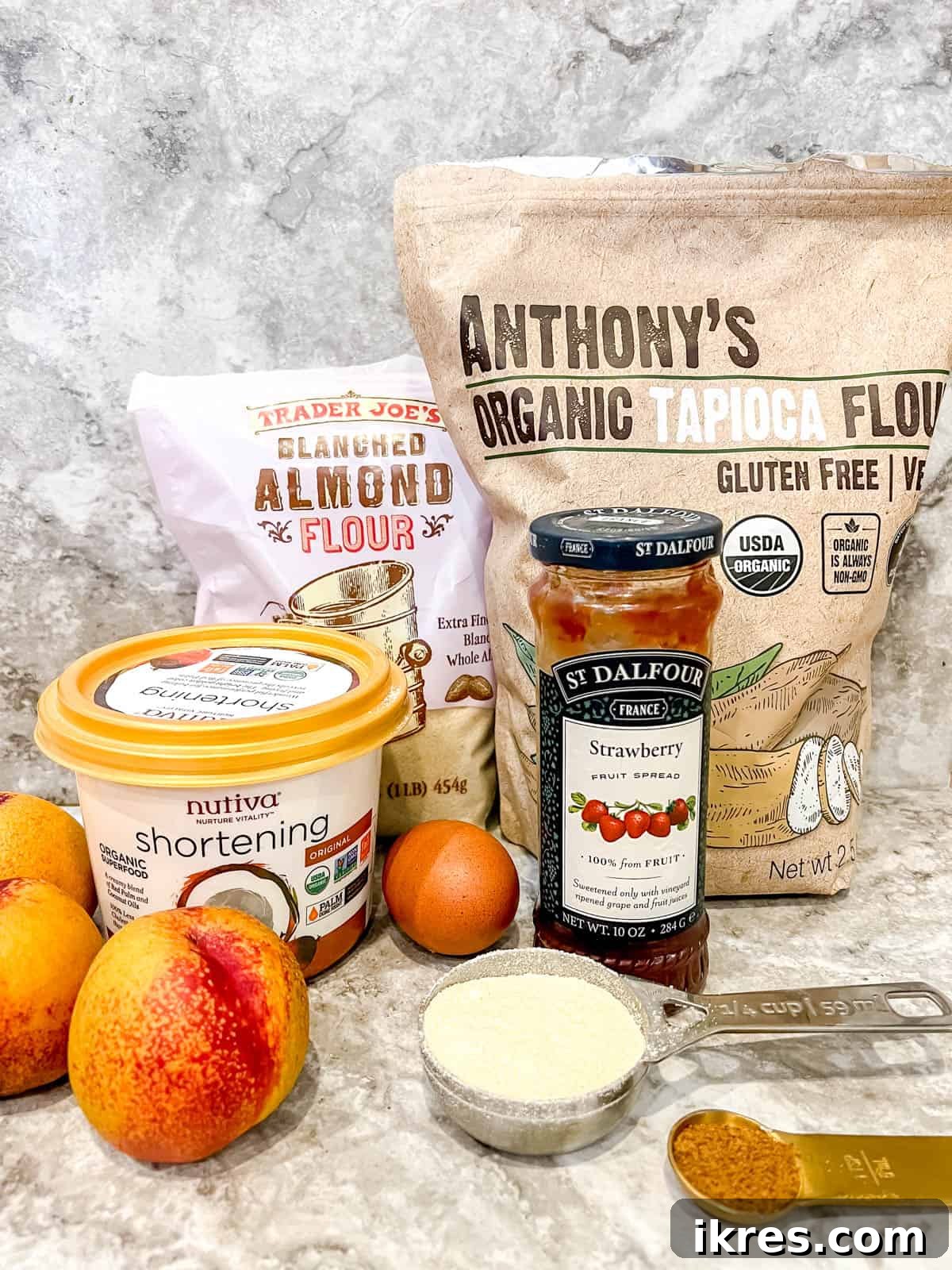 Various ingredients laid out for making the nectarine tart, including flours, shortening, eggs, and fresh nectarines.