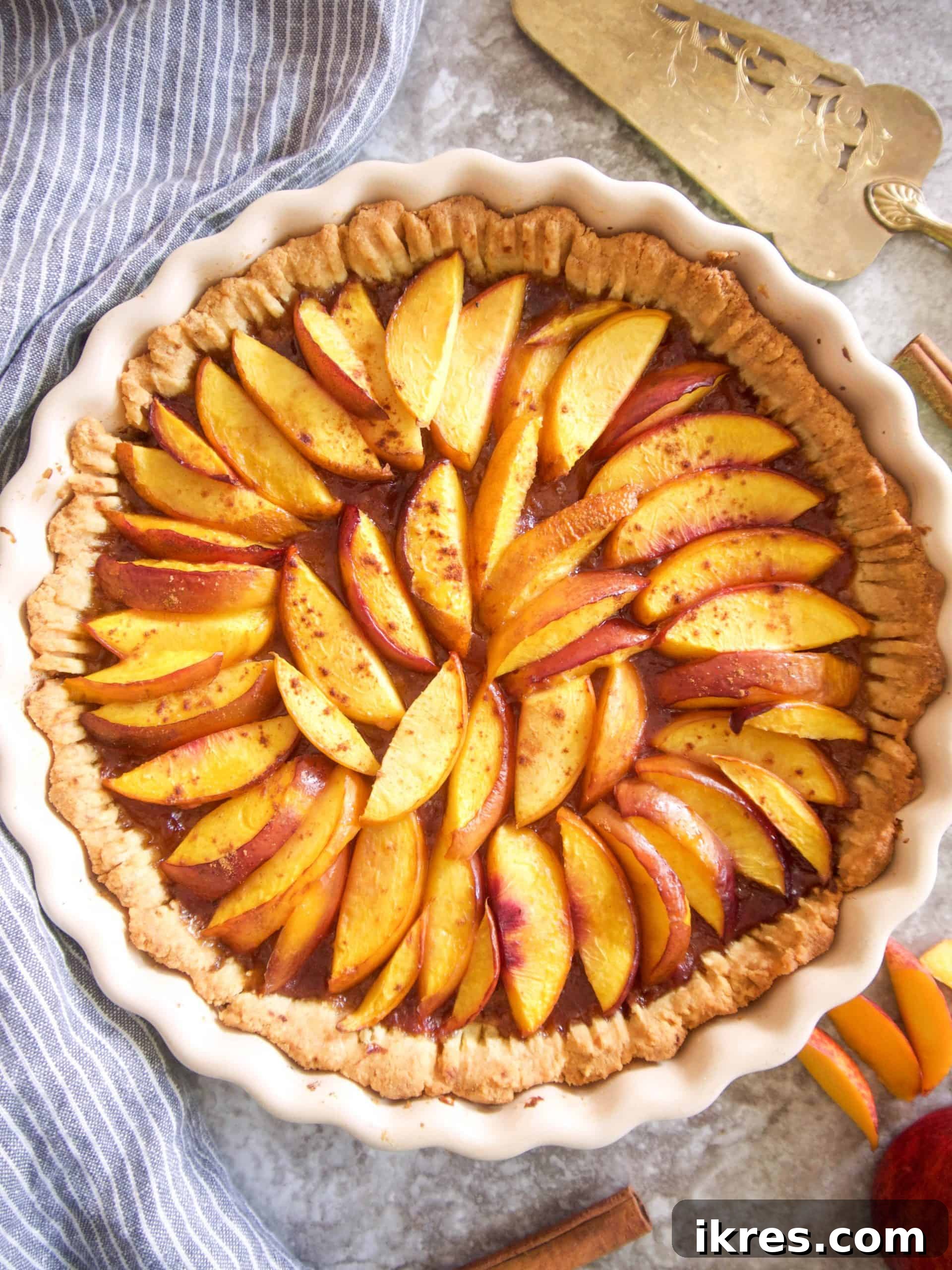 Golden-brown nectarine tart fresh out of the oven, with caramelized fruit.