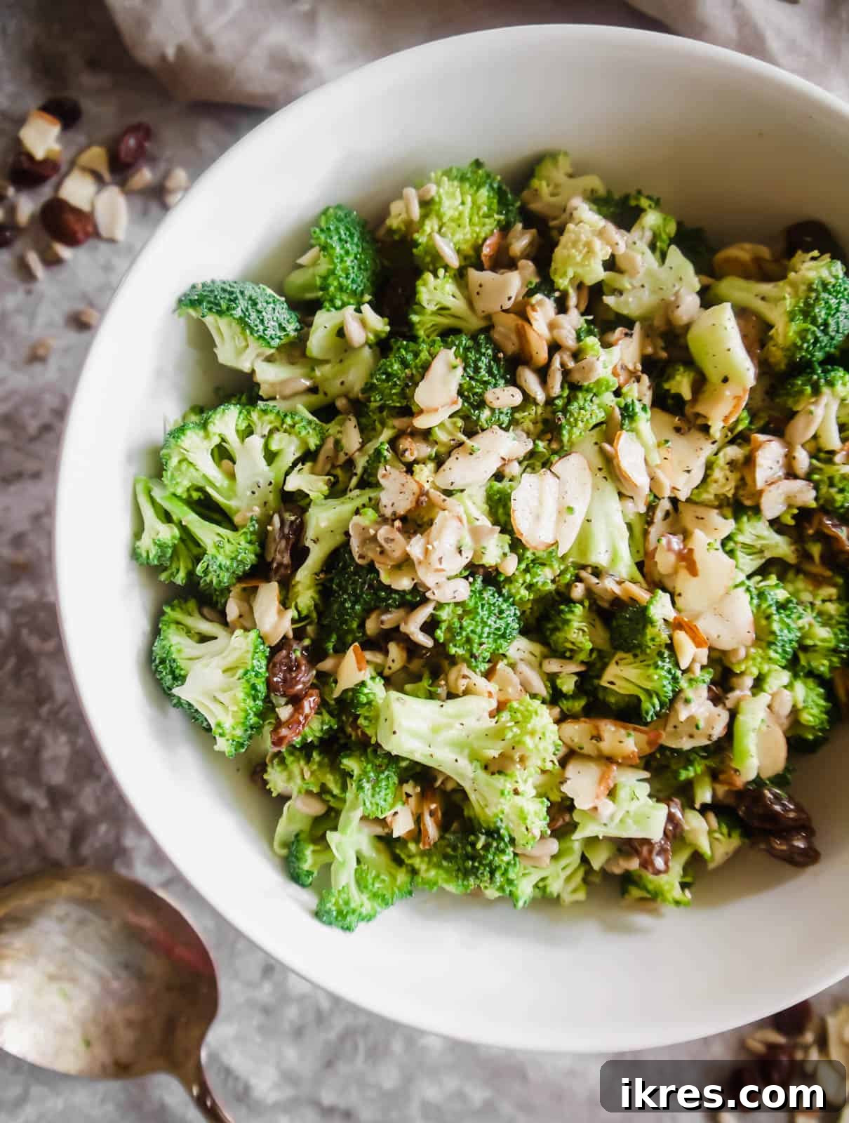 Light and Easy Broccoli Salad in a large bowl, garnished with fresh herbs.