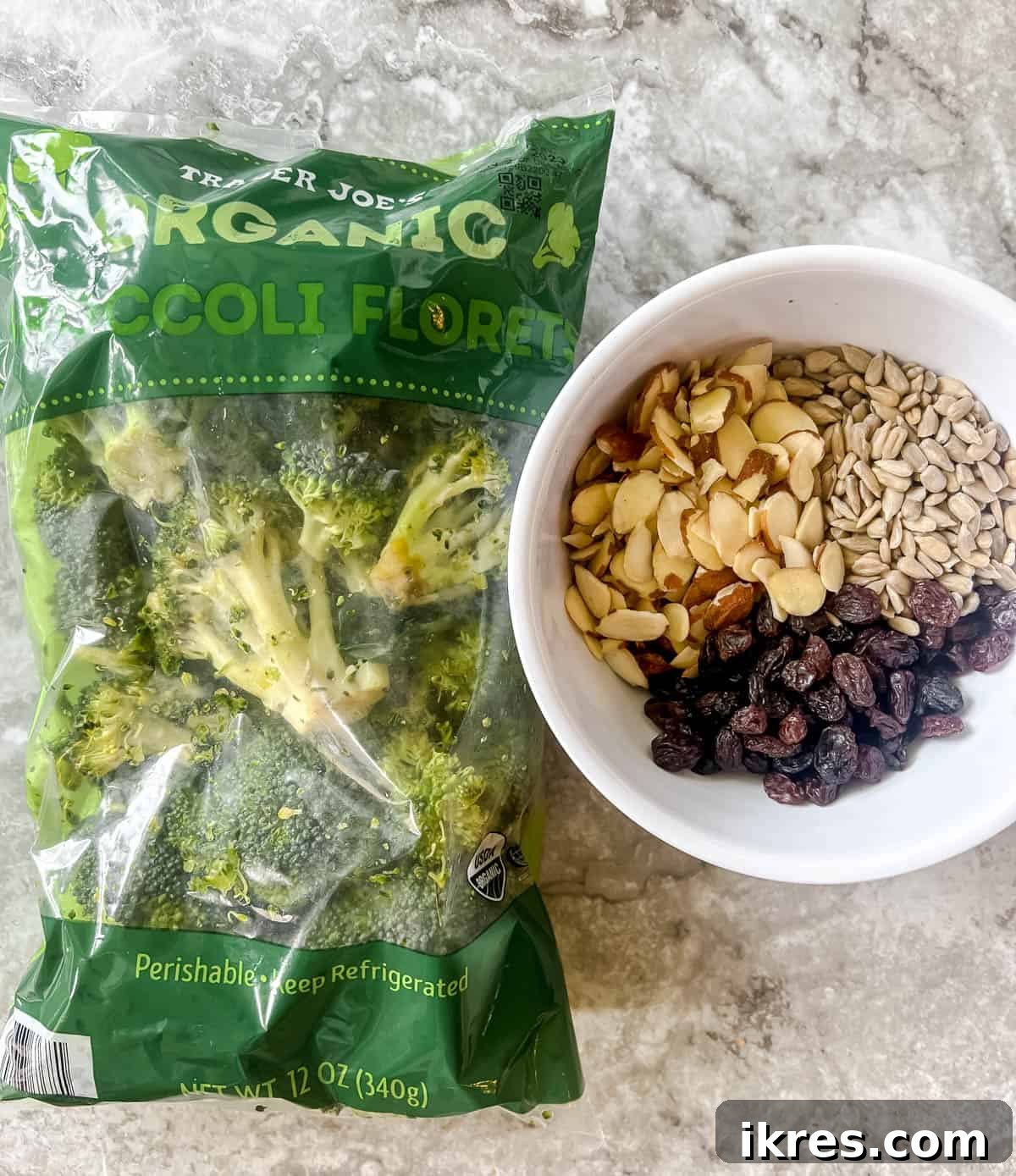 Assorted dry ingredients for healthy broccoli salad including raisins, almonds, and sunflower seeds.