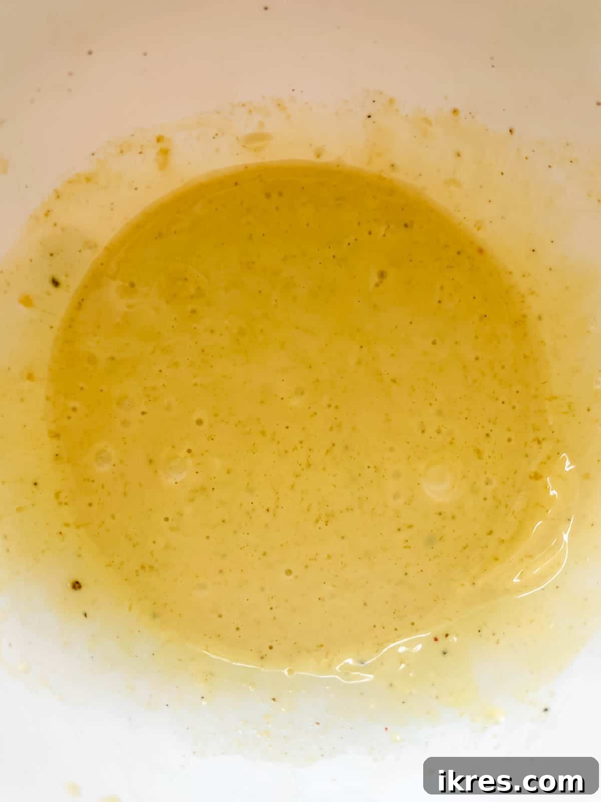 The creamy honey dijon mayo dressing mixed in a small bowl.