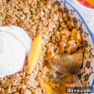 Nectarine Crisp in a baking dish with a spoon in it.