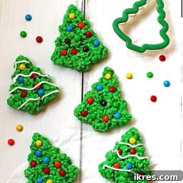 Green Rice Krispie Trees decorated with M&M candy and white icing.