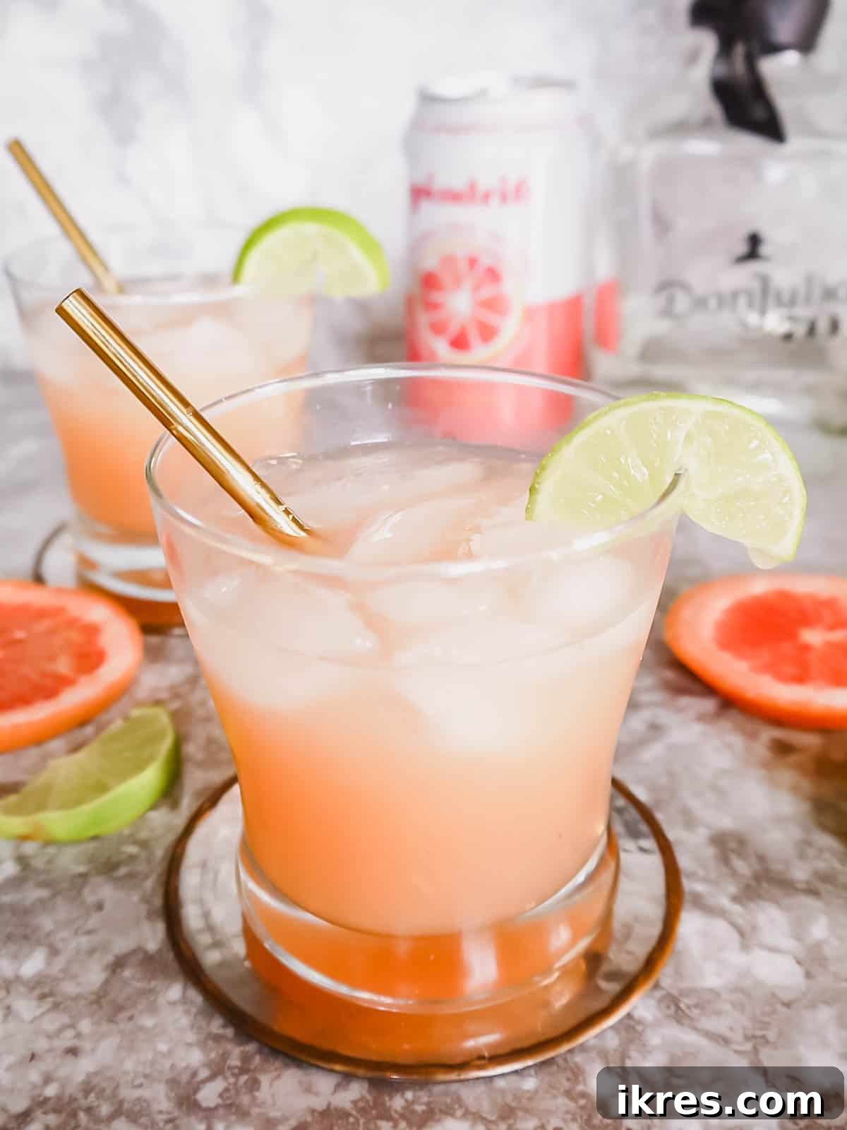 Naturally Sweet Honey Paloma 4 Two vibrant honey paloma cocktails served in elegant cups, showcasing the beautiful color and refreshing appeal of the drink.