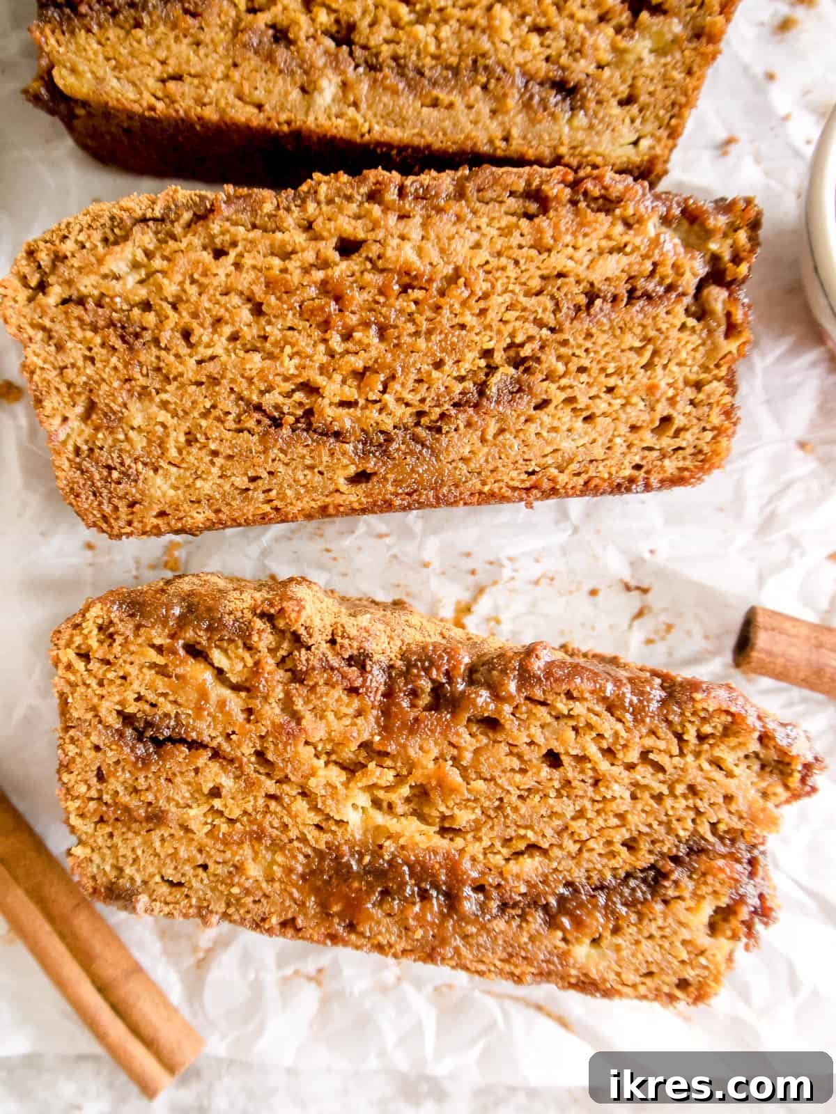 Wholesome Paleo Cinnamon Swirl Pumpkin Banana Bread 5 A beautiful loaf of almond flour pumpkin banana bread, freshly sliced to reveal its moist interior.