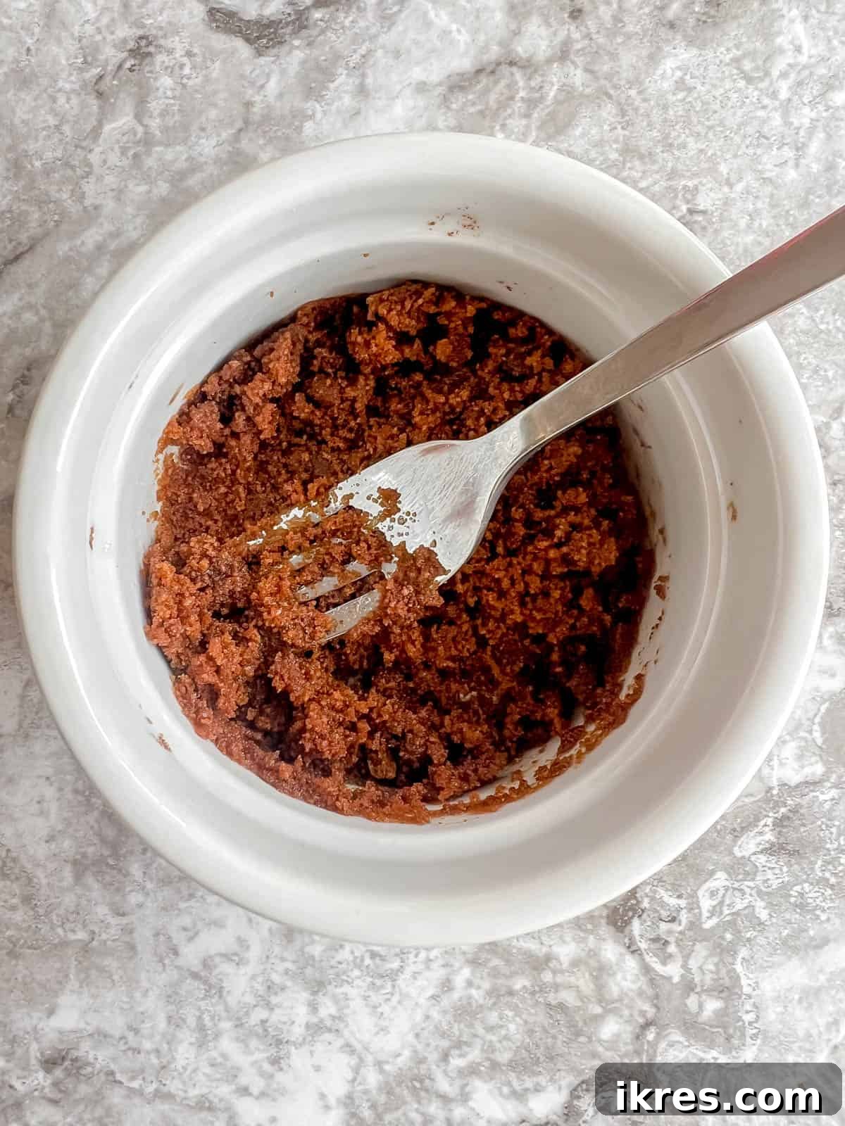 Easy Paleo Pumpkin Spice Mug Cake 5 Coconut sugar and olive oil combined in a ramekin, ready for mixing.