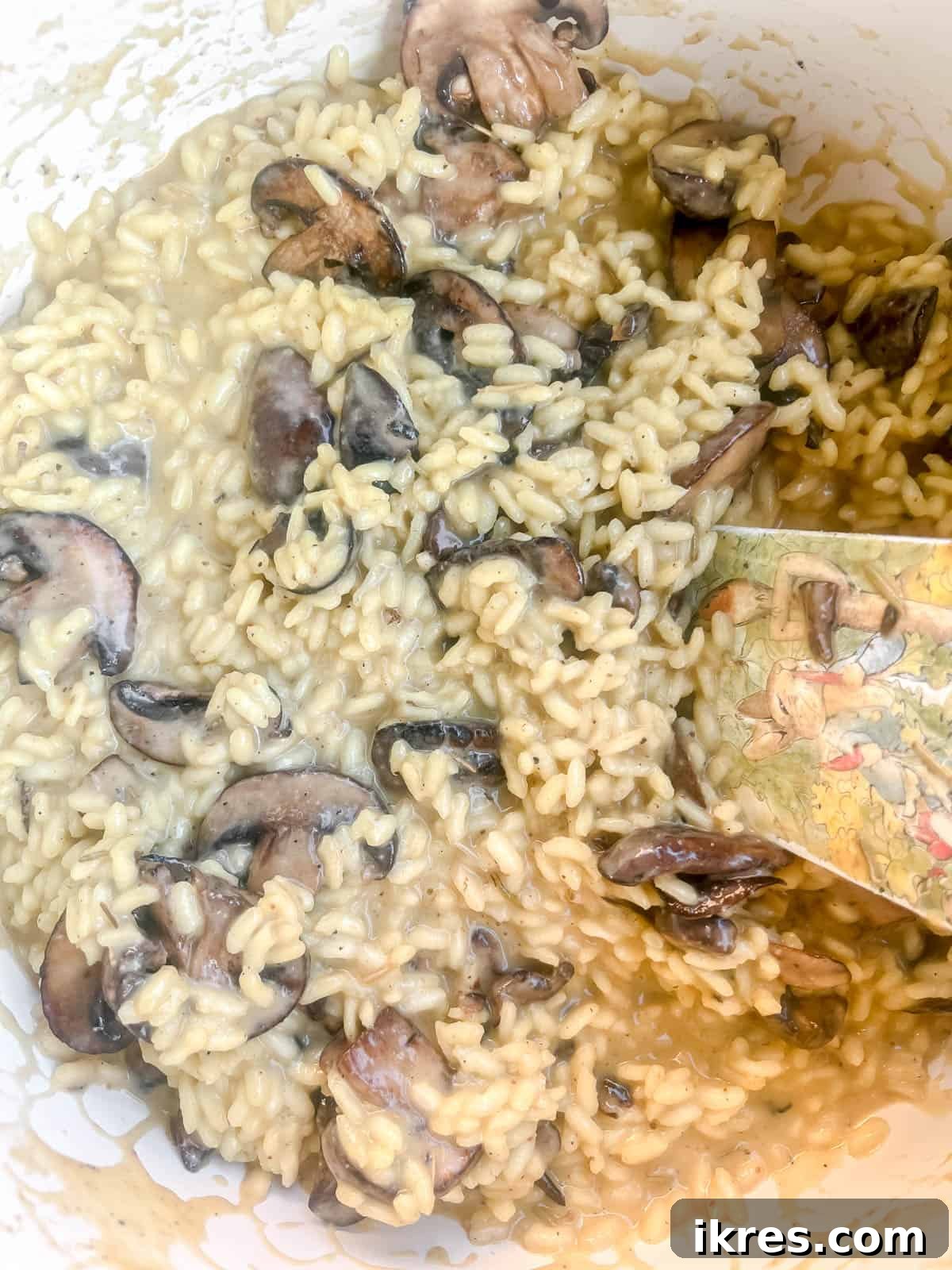 The completed dairy-free mushroom risotto in a pot, with sautéed mushrooms mixed in, ready for serving.