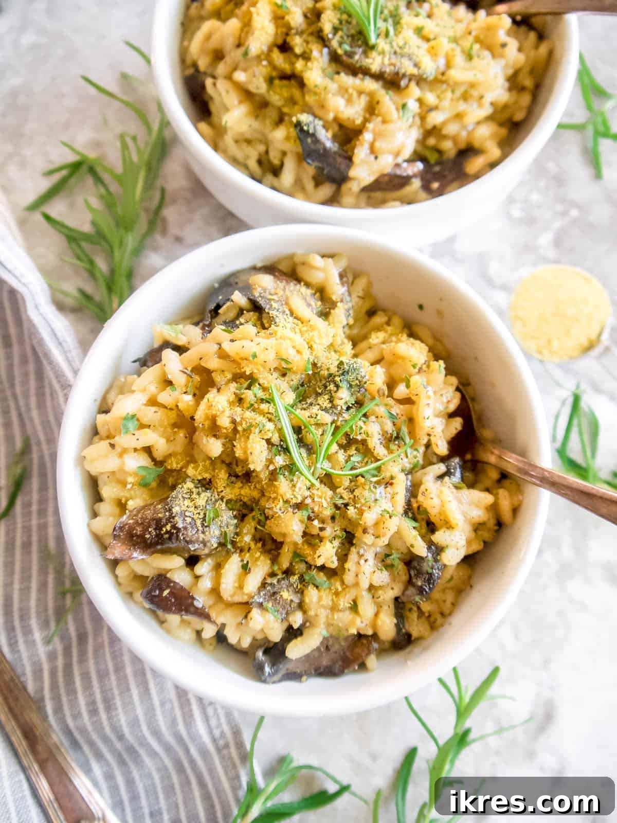 An aerial view of dairy-free mushroom risotto served in two white bowls, showcasing its creamy texture.