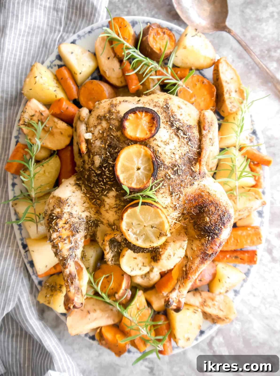 Golden Roast Chicken with Apples and Potatoes Dairy Free 8 Freshly roasted whole chicken with tender apples and potatoes on a serving plate, steaming hot.