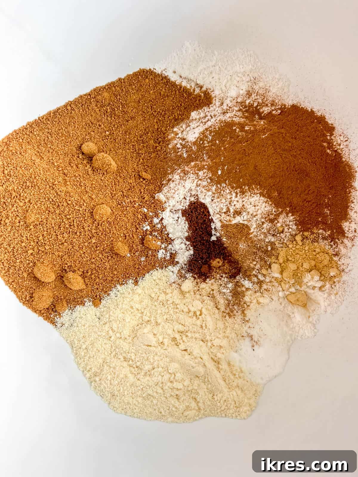 Dry ingredients for paleo pumpkin muffins mixed in a bowl.