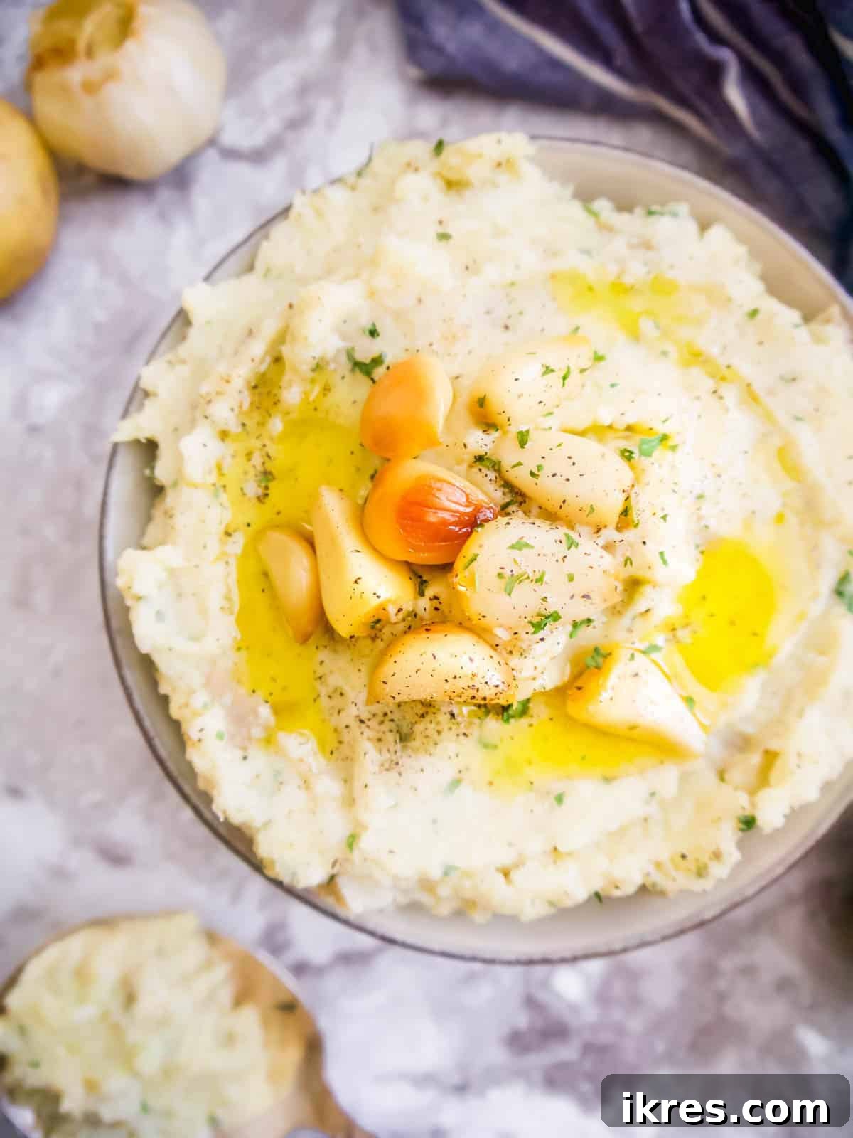 Roasted Garlic Mashed Cauliflower and Potatoes, a delicious Paleo and Whole30 twist on a classic mashed potato recipe.