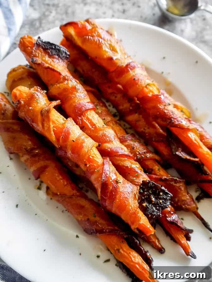 Prepared carrots and bacon strips laid out for wrapping.