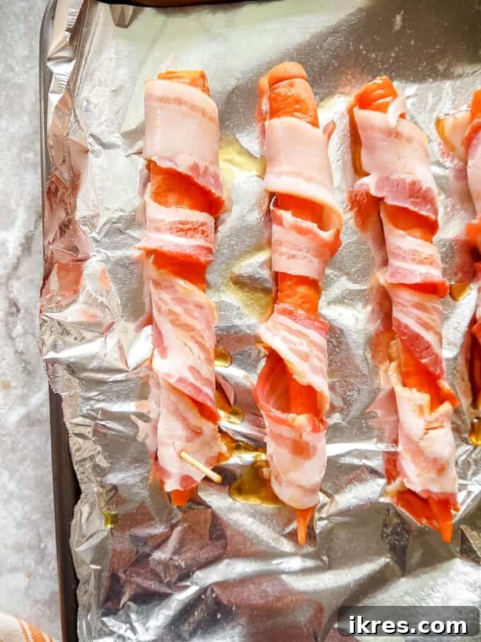 Step-by-step: Continuing to wrap the carrot with bacon.