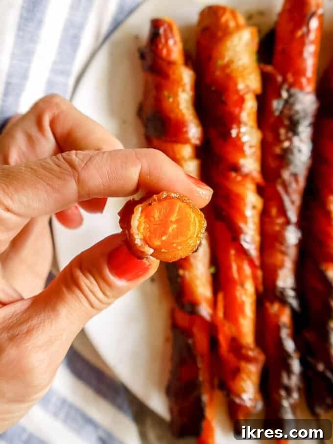 Freshly baked Maple Bacon Wrapped Carrots with a final drizzle of maple syrup.