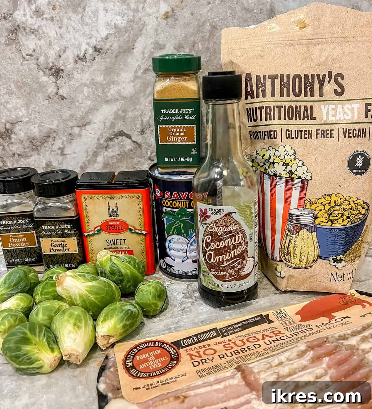Wholesome Brussels Sprouts Bake Paleo Whole30 4 A selection of fresh ingredients laid out on a counter, including Brussels sprouts, bacon, coconut cream, and spices, ready for making the dairy-free casserole.