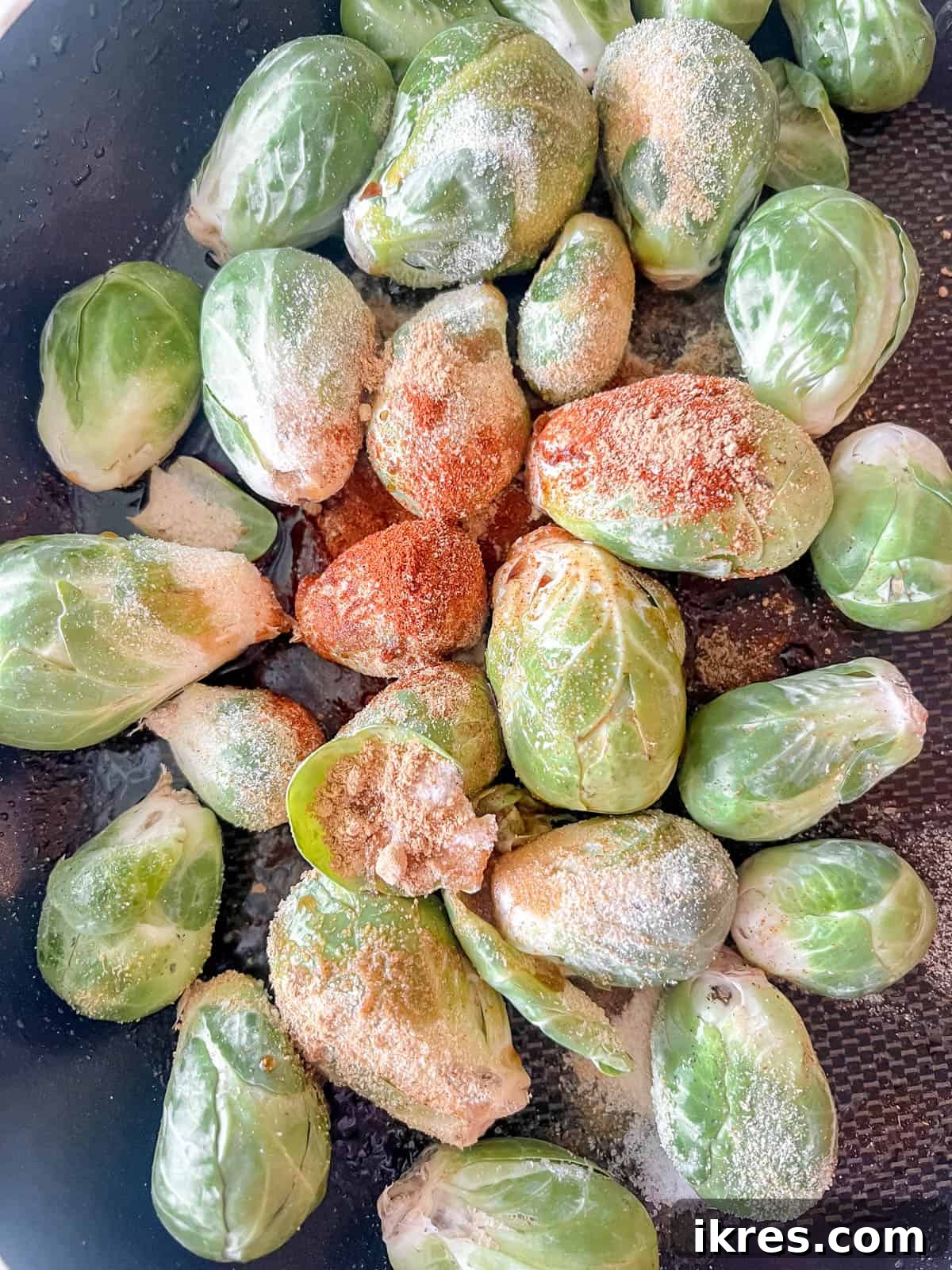 Wholesome Brussels Sprouts Bake Paleo Whole30 6 Fresh Brussels sprouts in a large oven-safe skillet, tossed with olive oil and a vibrant blend of spices.