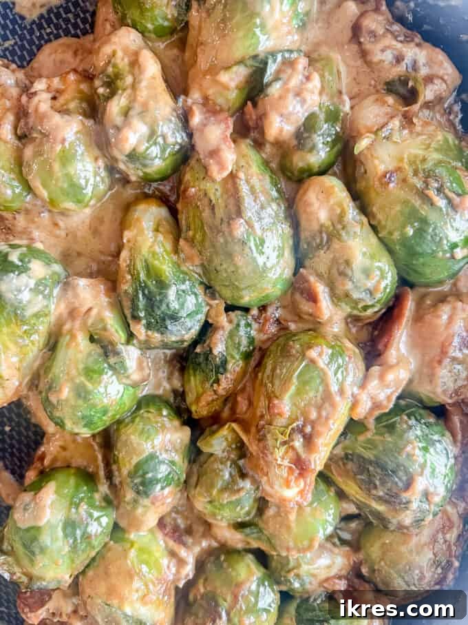 Wholesome Brussels Sprouts Bake Paleo Whole30 9 The creamy sauce, nutritional yeast, and bacon thoroughly mixed with the Brussels sprouts in the skillet, creating a cohesive casserole base.