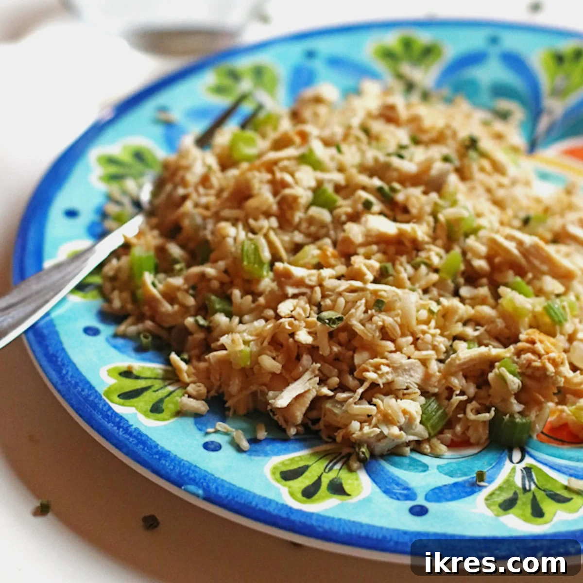Effortless Chicken Stir-Fry 3 A vibrant blue plate filled with a generous serving of homemade chicken stir fry, showcasing tender chicken, colorful vegetables, and perfectly cooked brown rice.