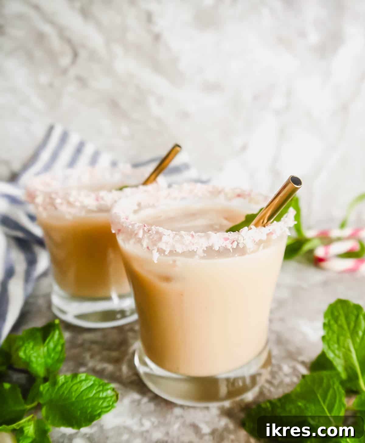Frosted Peppermint White Russian 5 Two glasses of mint white russians, beautifully presented on a wooden surface.