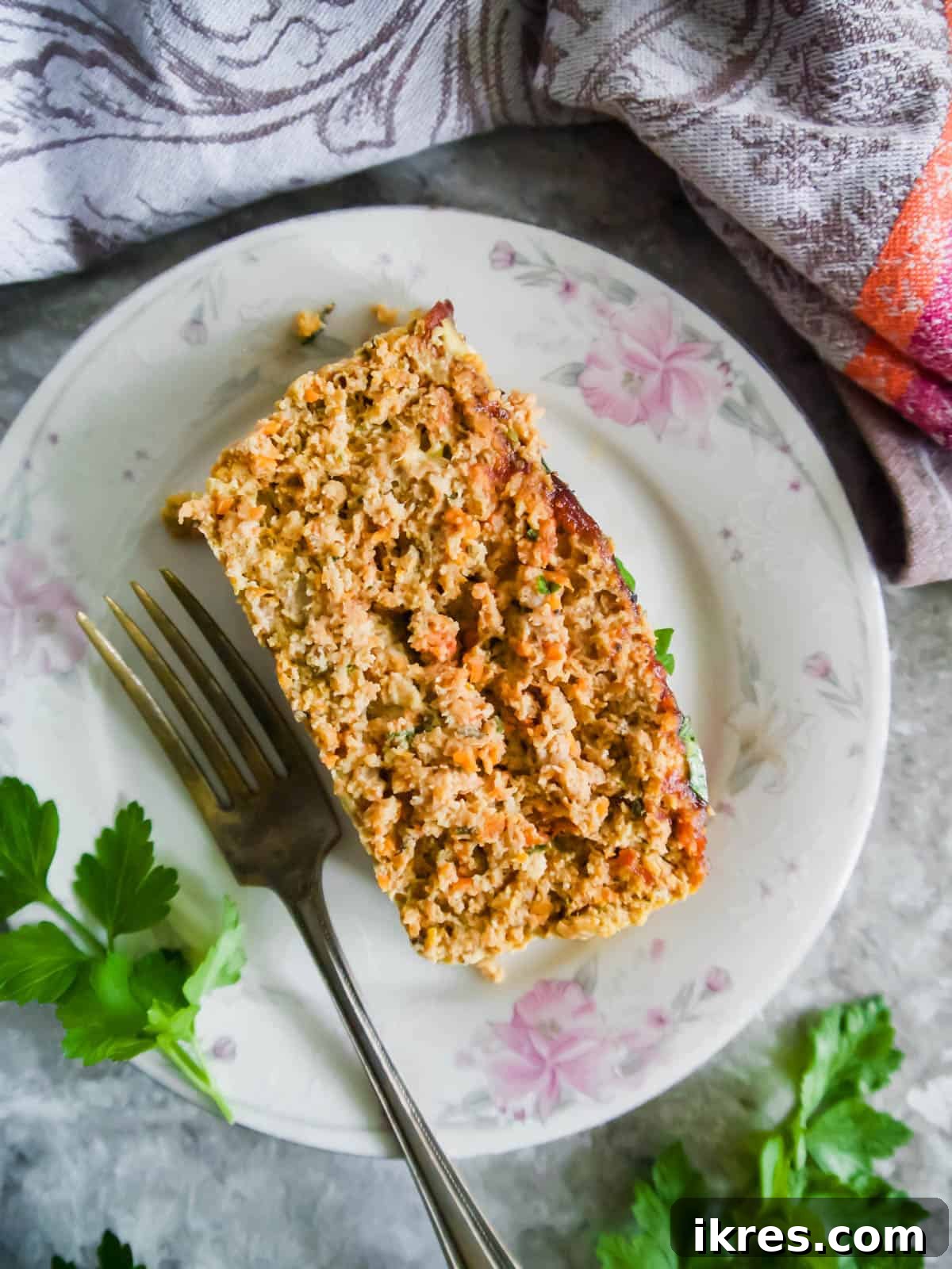 Lean Poultry Power Meatloaf 11 A beautifully plated slice of Healthy Ground Chicken and Turkey Meatloaf, garnished and ready to eat.
