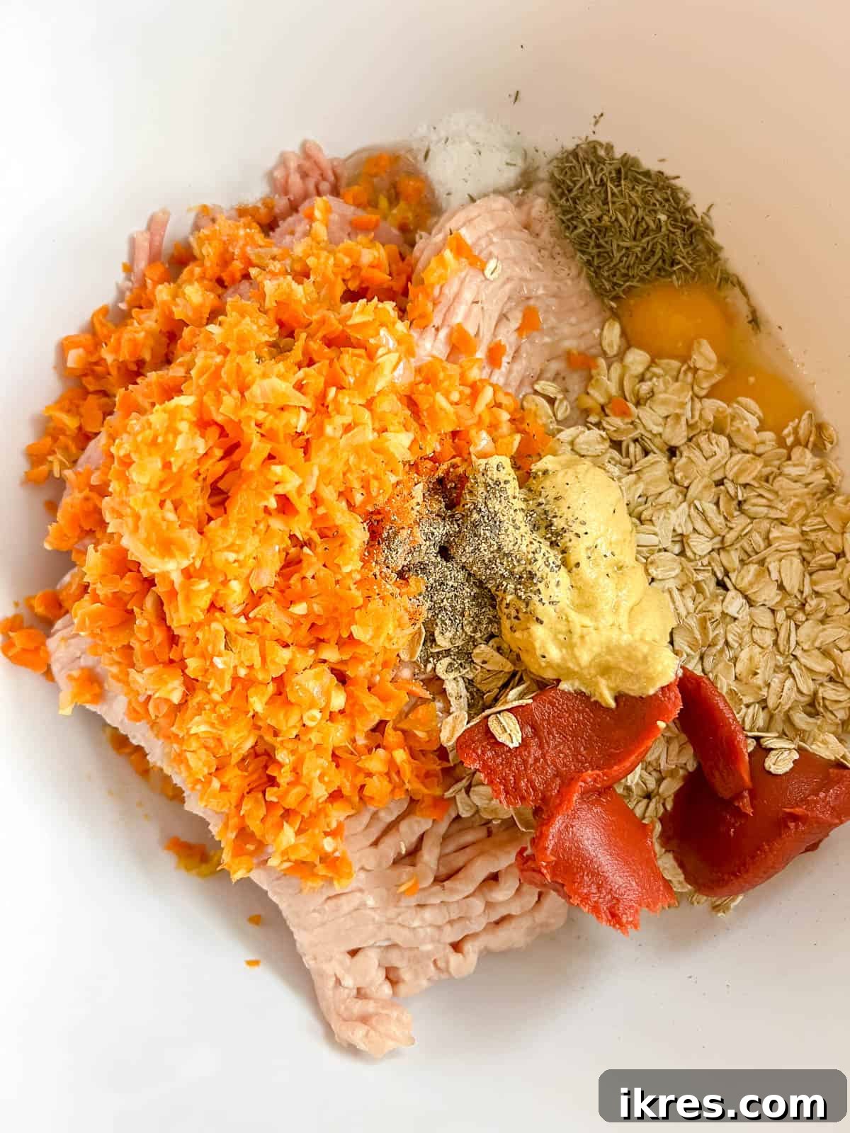 All the meatloaf ingredients gathered in a large mixing bowl.