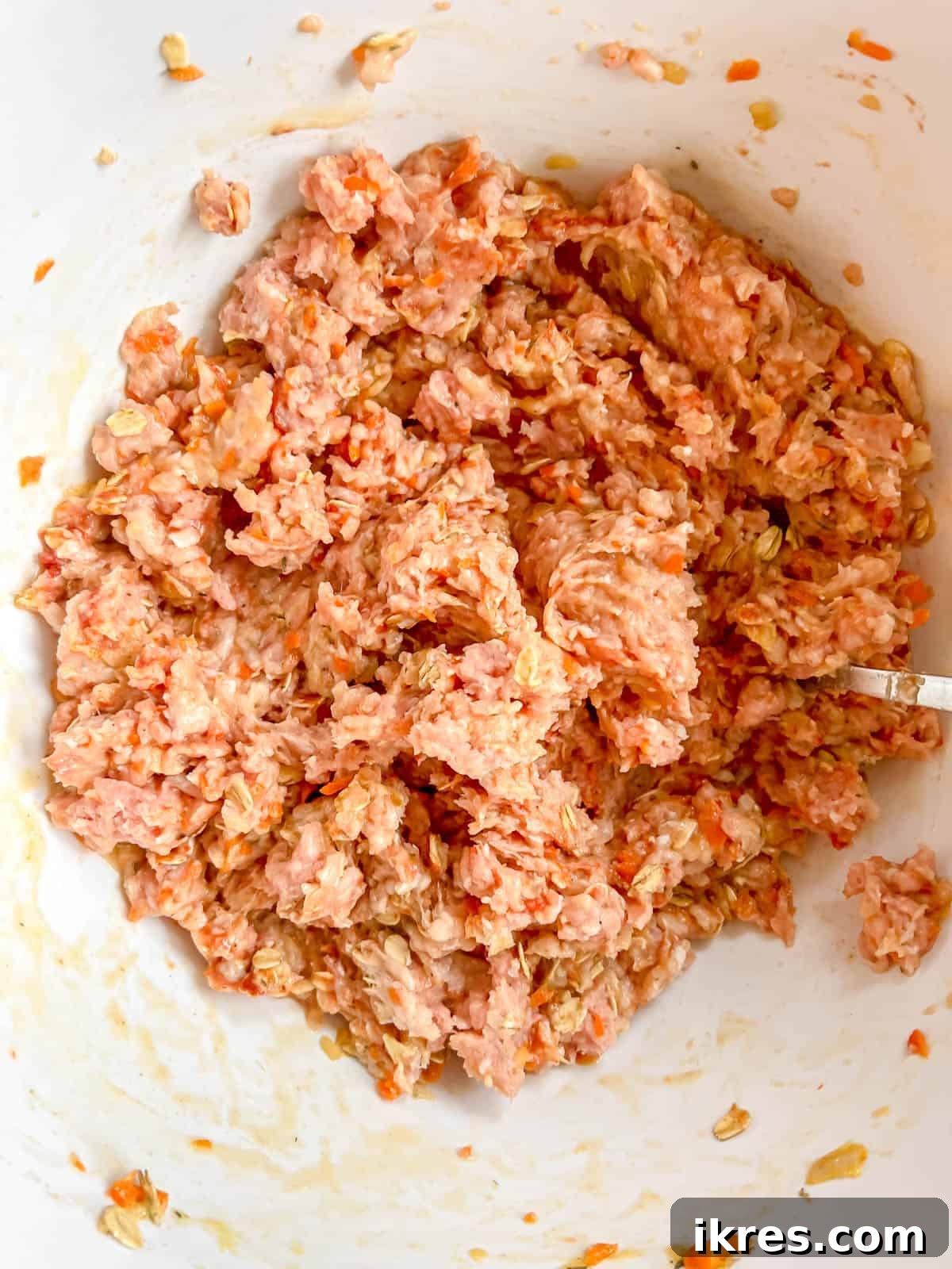 Meatloaf ingredients thoroughly mixed together in a bowl.