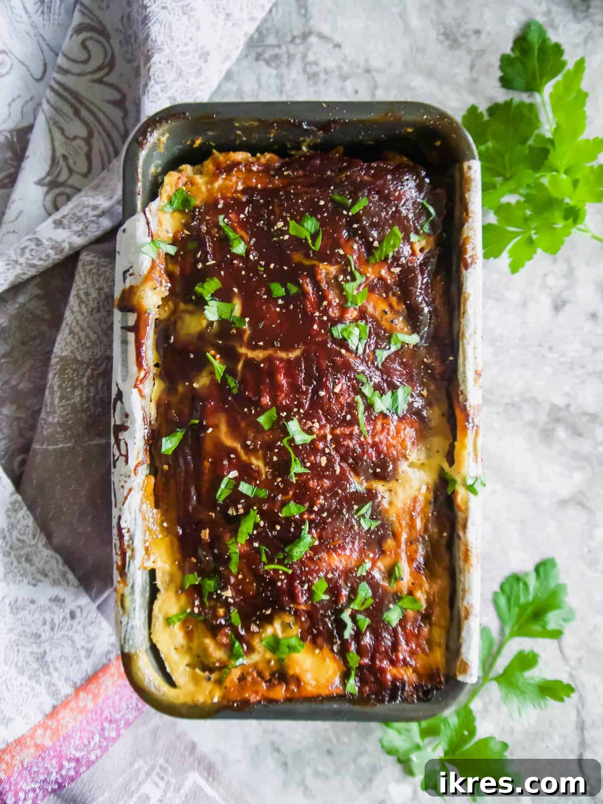 Baked ground turkey meatloaf in a loaf tin after cooking.
