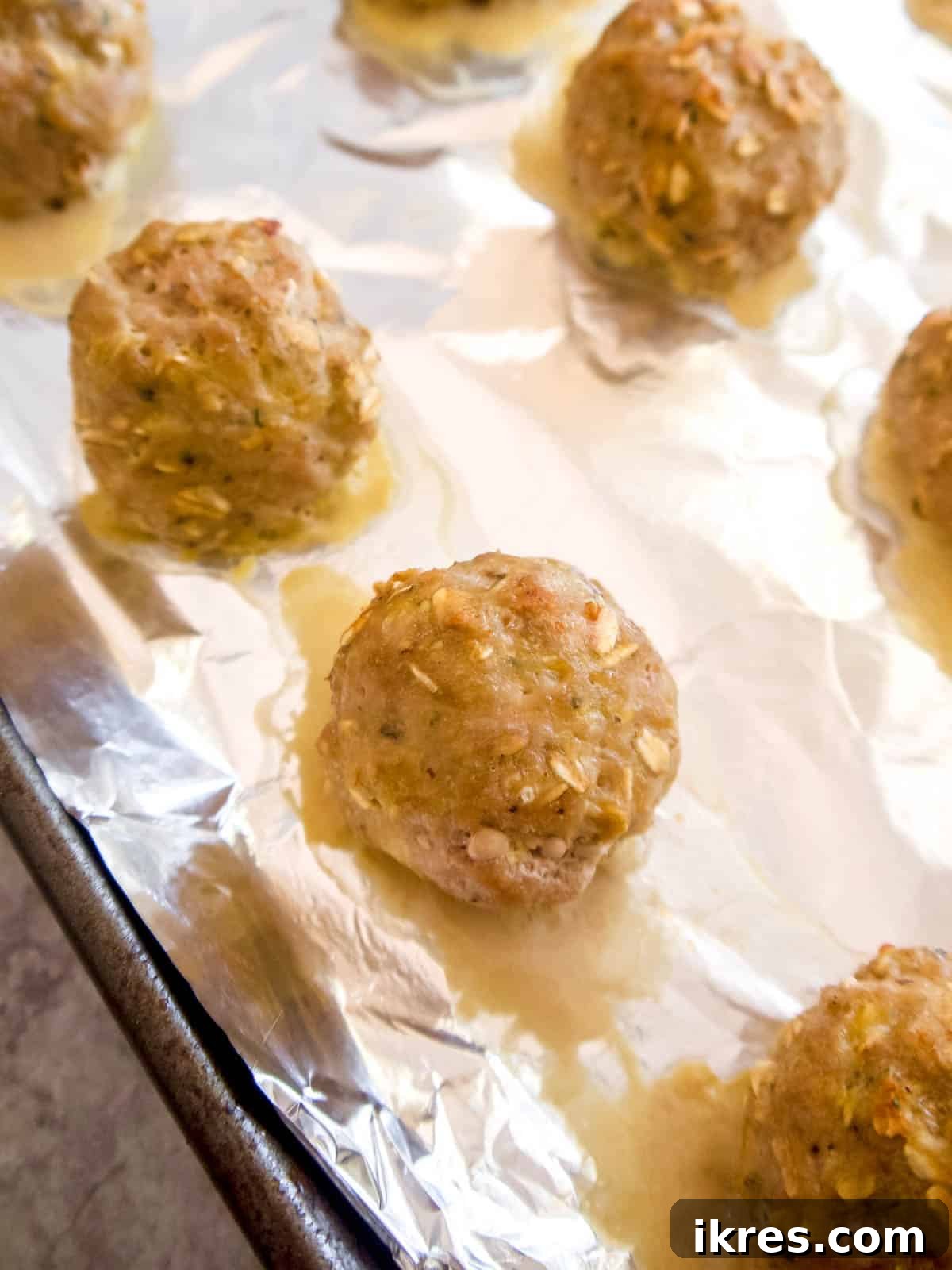 Gluten Free Dairy Free Turkey Meatballs with Oats 8 A close-up of a batch of freshly baked turkey oat meatballs, golden brown and perfectly cooked.