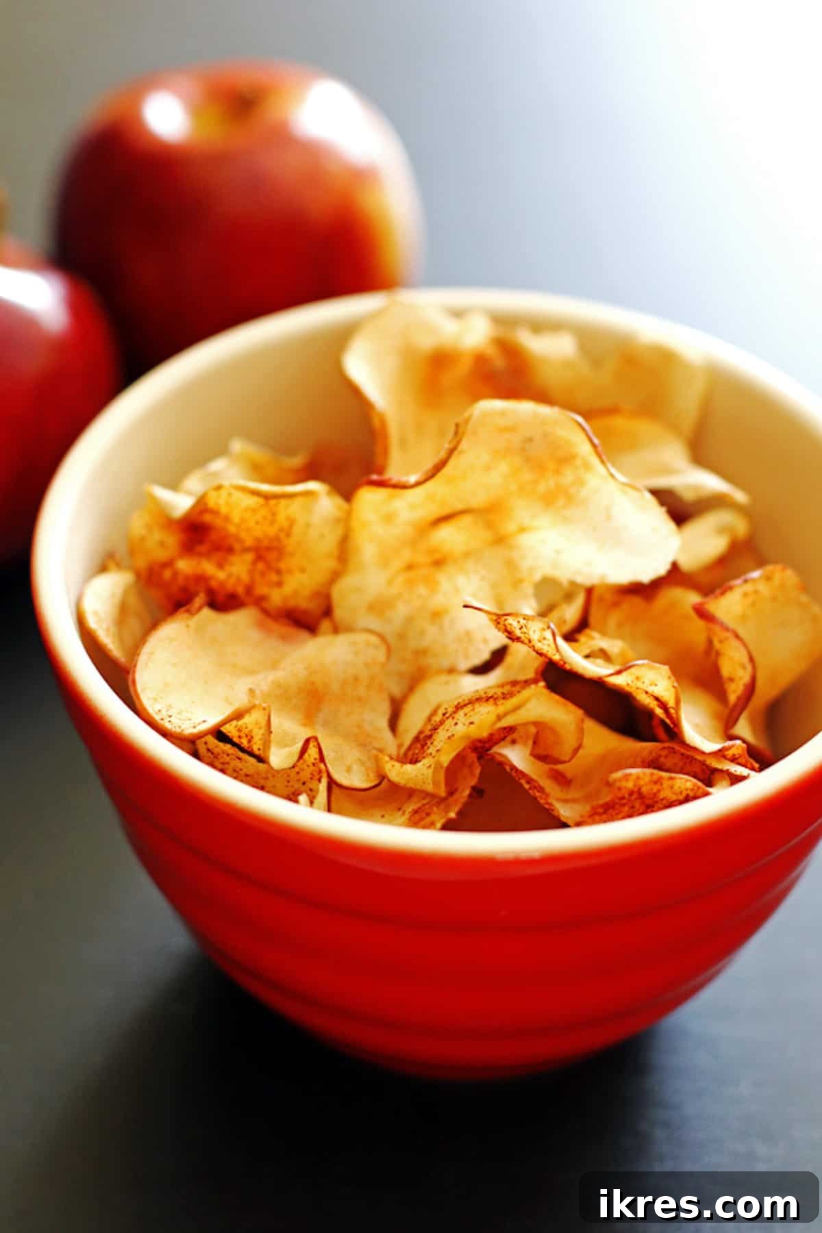 Sweet & Crunchy Oven Apple Treats 2 A bowl of baked apple chips, perfectly golden and crispy.