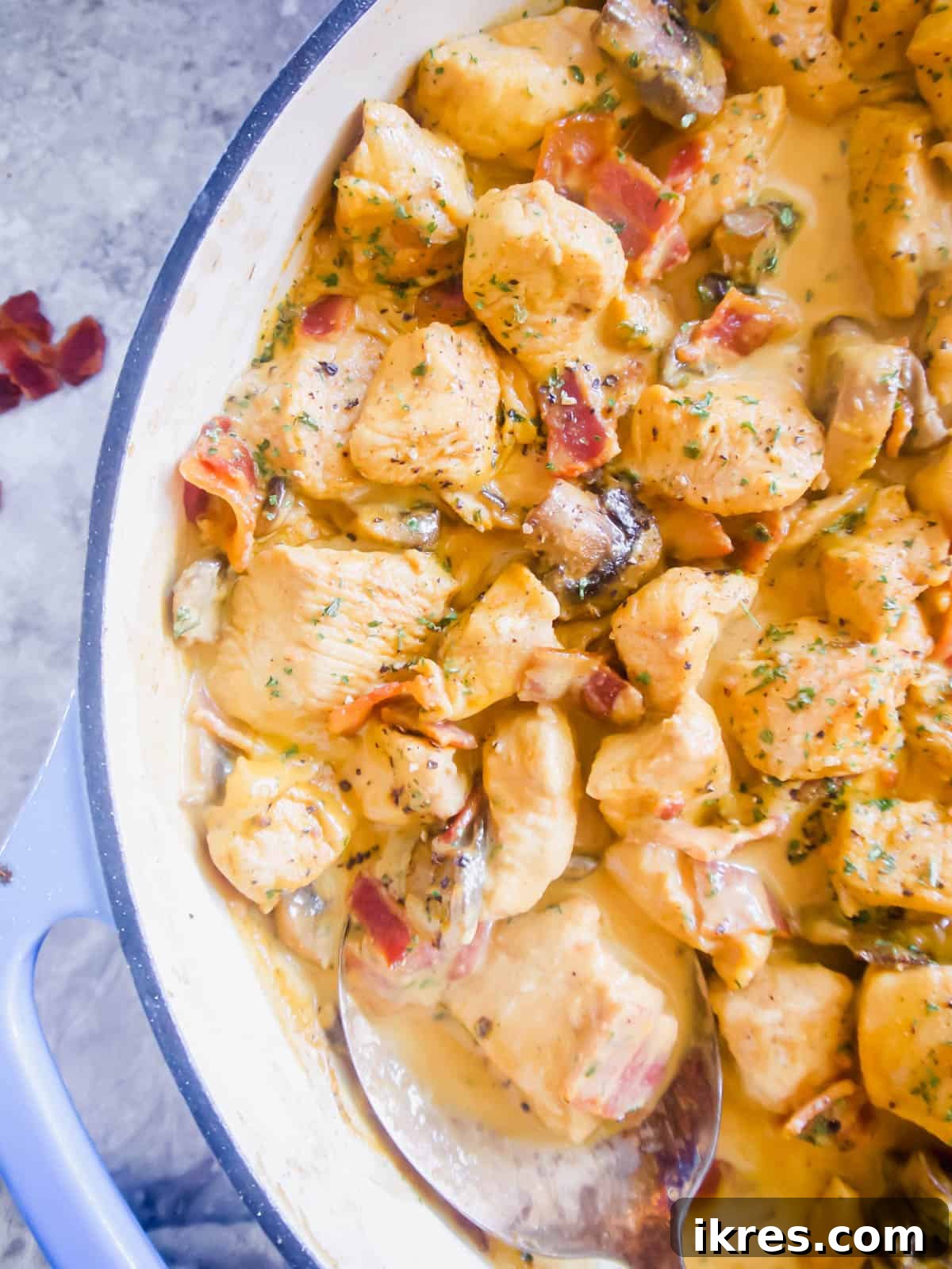 Plated Creamy Dairy-Free Bacon and Mushroom Chicken, garnished with parsley, ready to serve.