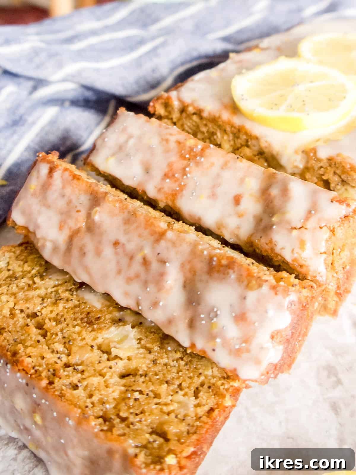 Zesty Paleo Lemon Poppy Seed Banana Bread 3 Freshly sliced gluten-free lemon poppy seed bread, showing its moist interior and scattered poppy seeds.