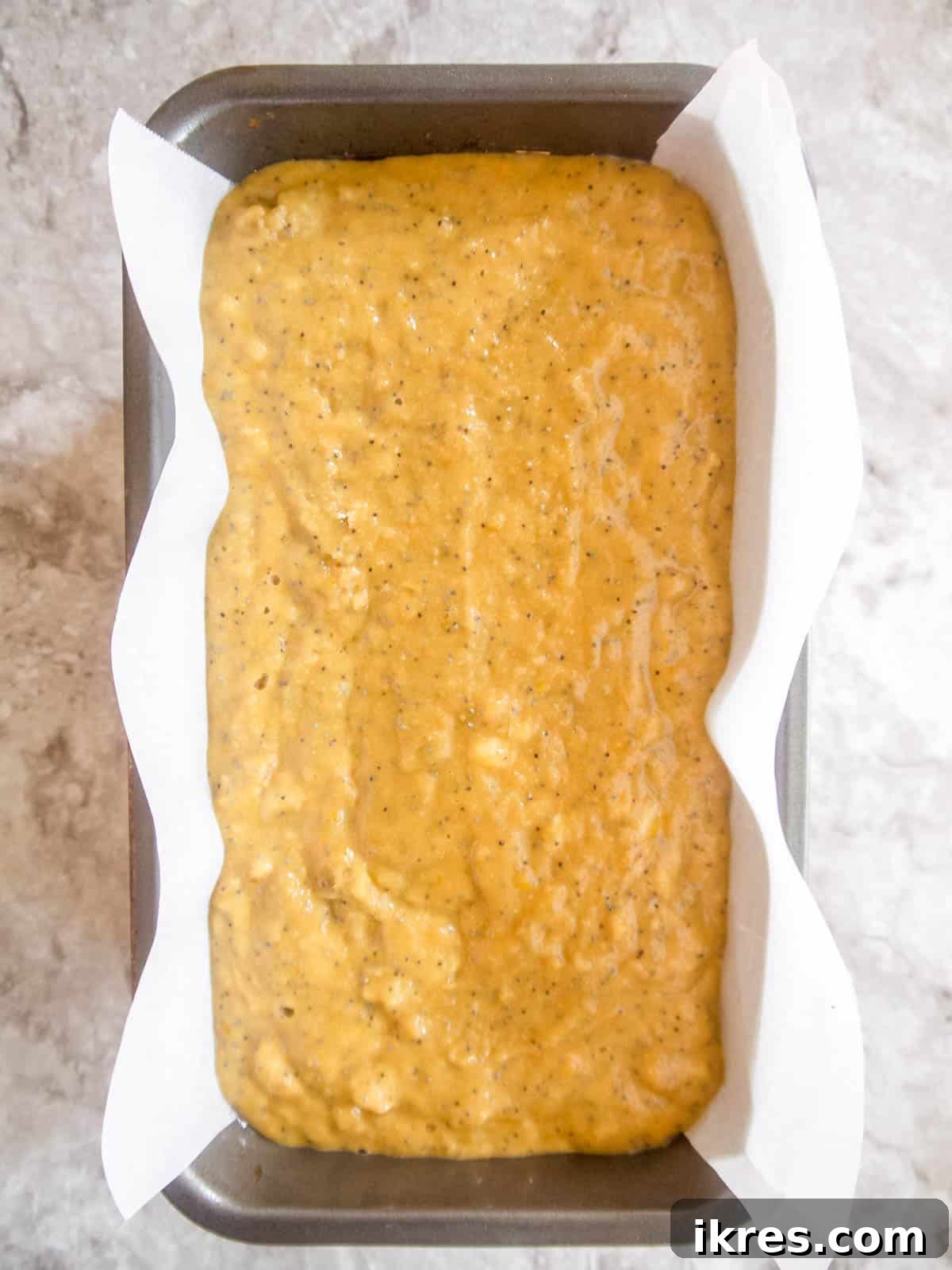 Zesty Paleo Lemon Poppy Seed Banana Bread 8 The banana bread batter poured into a loaf pan, ready for baking.