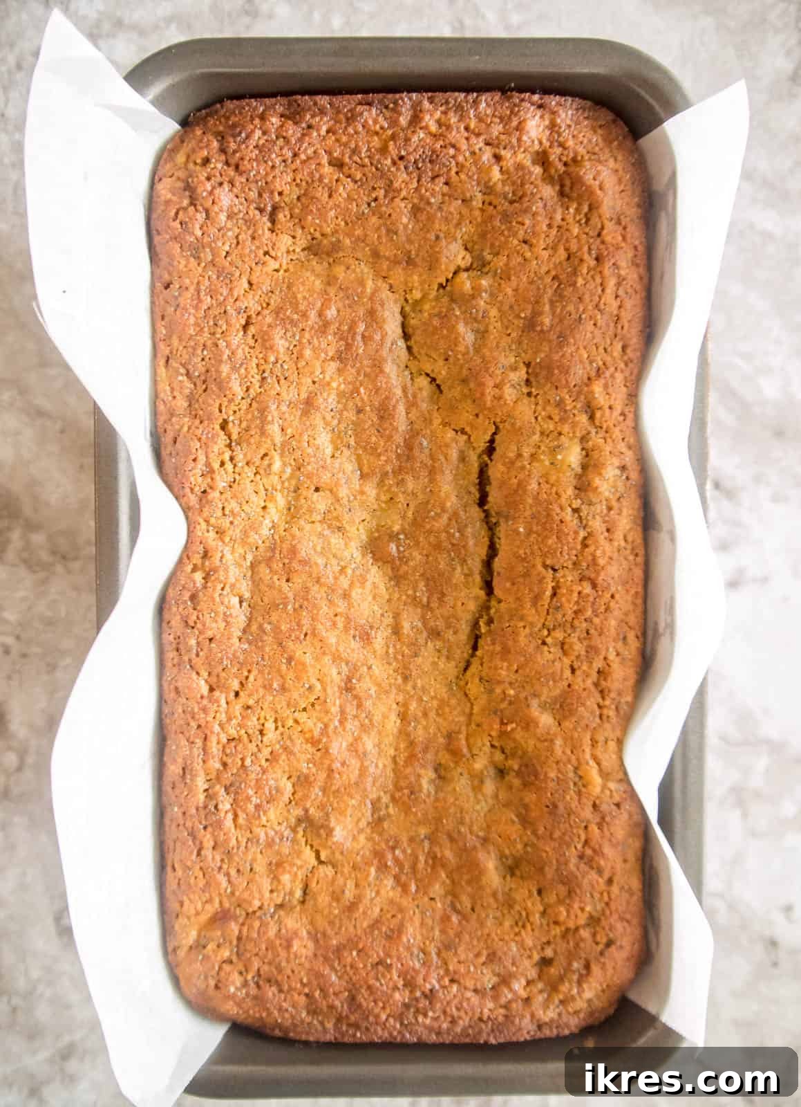 Zesty Paleo Lemon Poppy Seed Banana Bread 9 A freshly baked loaf of lemon poppy seed banana bread, golden brown and perfectly risen.