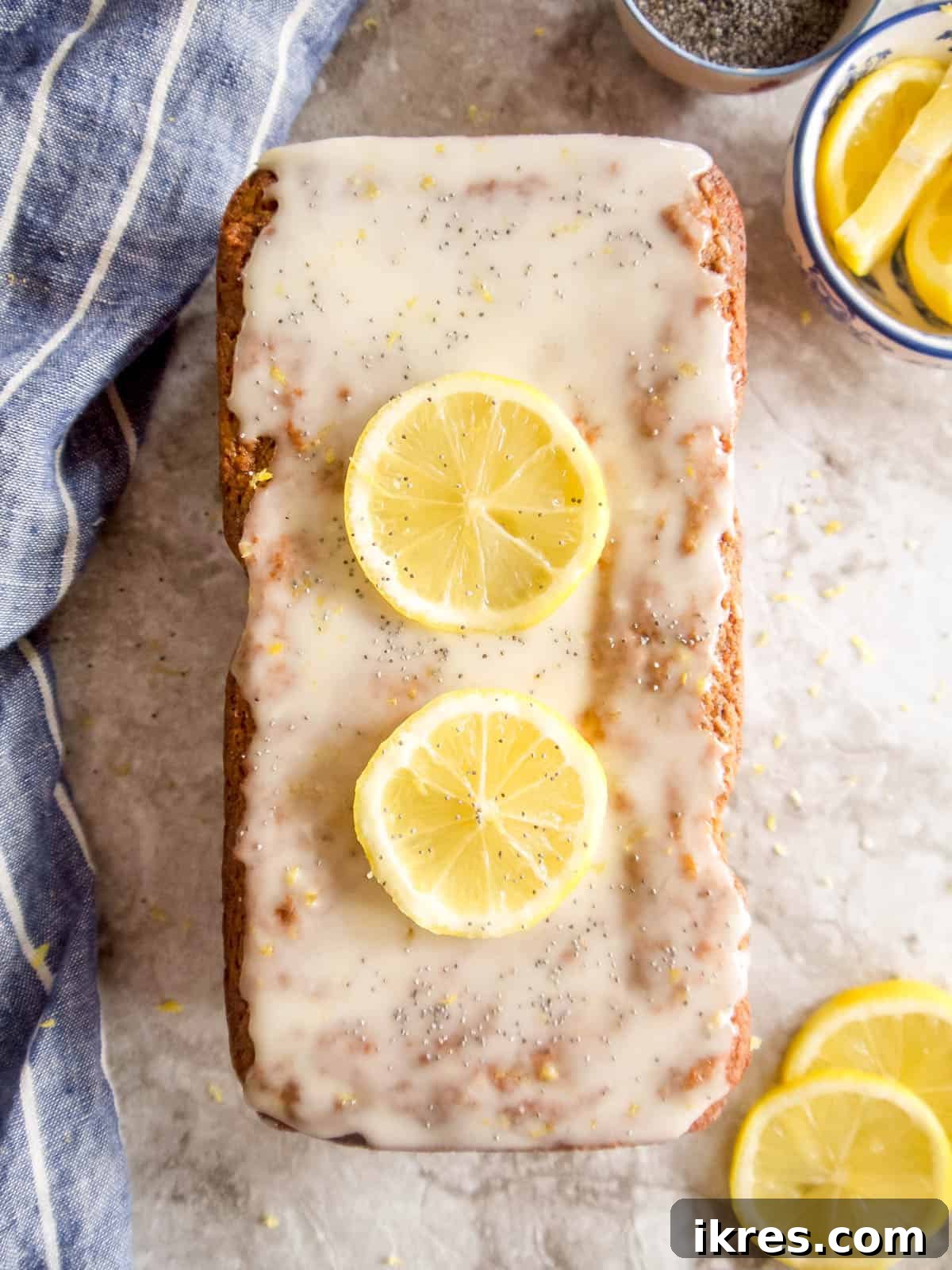 Zesty Paleo Lemon Poppy Seed Banana Bread 10 Close-up of the lemon glaze being drizzled over the baked lemon poppy seed banana bread.