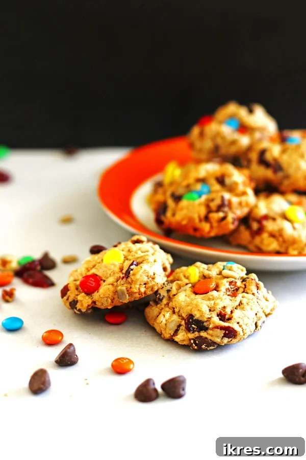 Closeup of freshly baked Trail Mix Cookies cooling on a rack, showing their chewy texture.