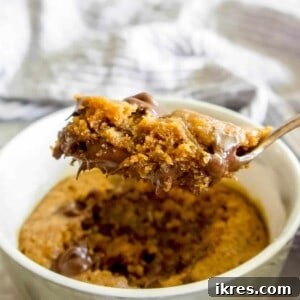 Guilt-Free Paleo Mug Cookie Delight 9 A spoon of Gluten-free Mug Cookie being lifted out of a ramekin.
