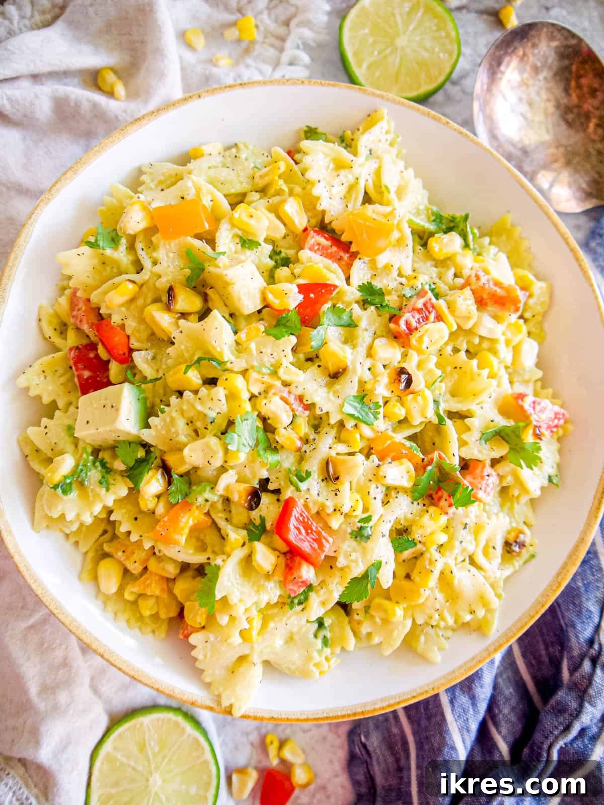 Dairy-free Mexican Street Corn Pasta Salad in a large bowl ready to be served, garnished with fresh cilantro.