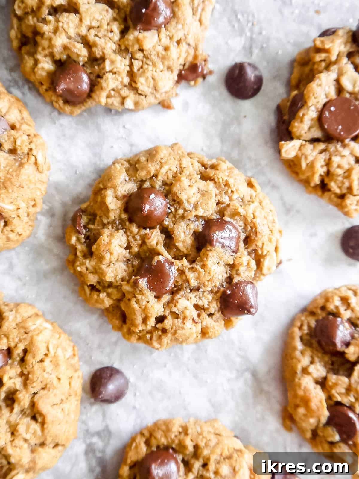 Wholesome Gluten Free Dairy Free Almond Oatmeal Treats 11 A large pile of warm, inviting almond flour oat cookies on a wooden table, ready to be enjoyed.