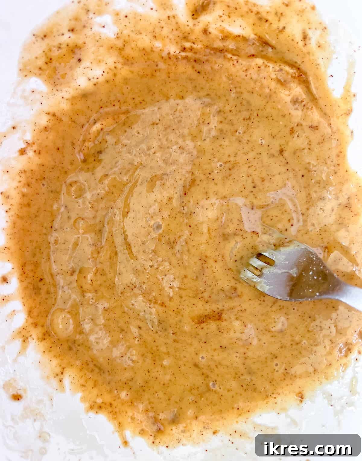 Wholesome Gluten Free Dairy Free Almond Oatmeal Treats 6 Wet ingredients for almond oatmeal cookies, including egg, almond butter, olive oil, and vanilla, blended in a separate bowl.