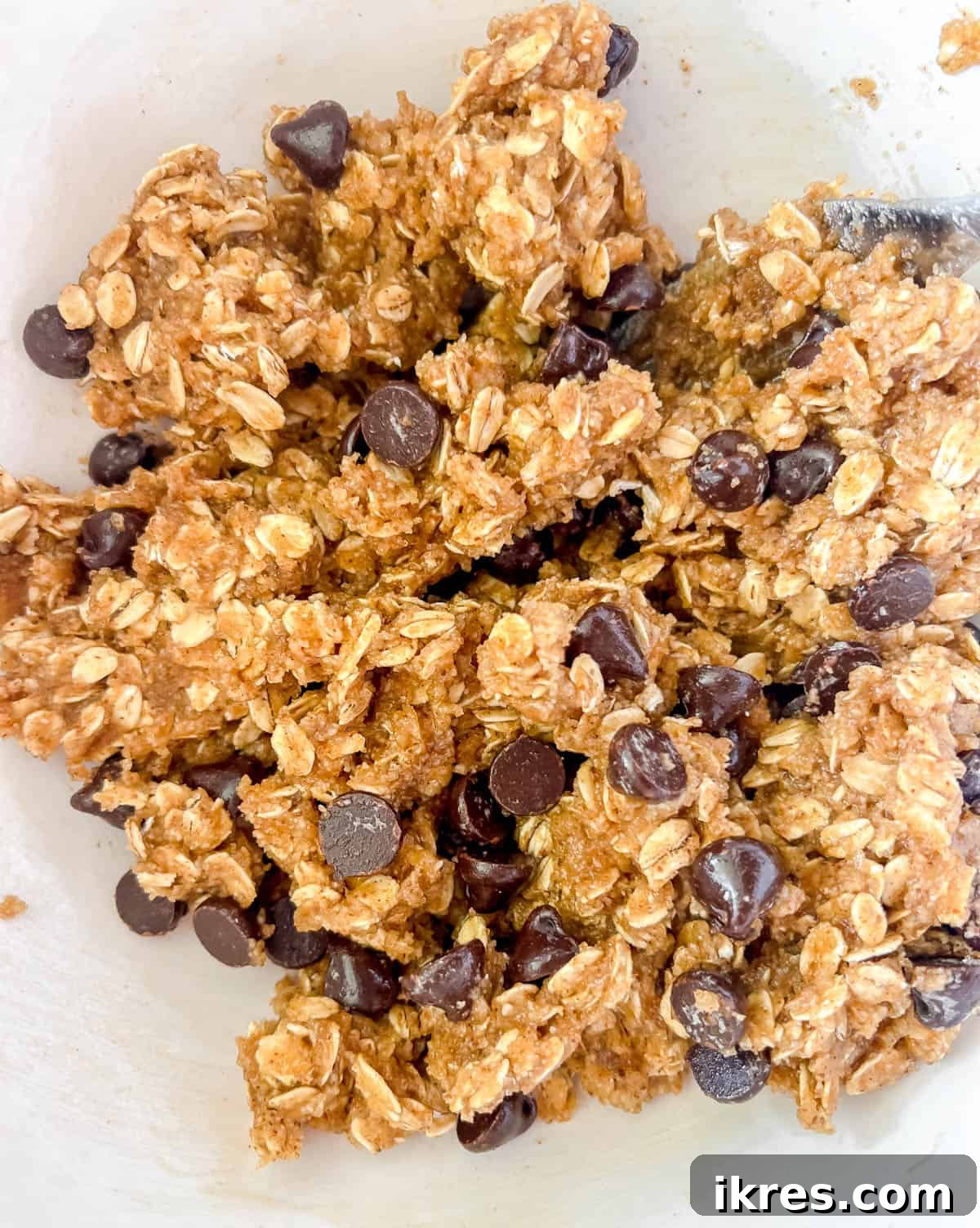 Wholesome Gluten Free Dairy Free Almond Oatmeal Treats 8 Dairy-free chocolate chips being folded into the almond oatmeal cookie batter.
