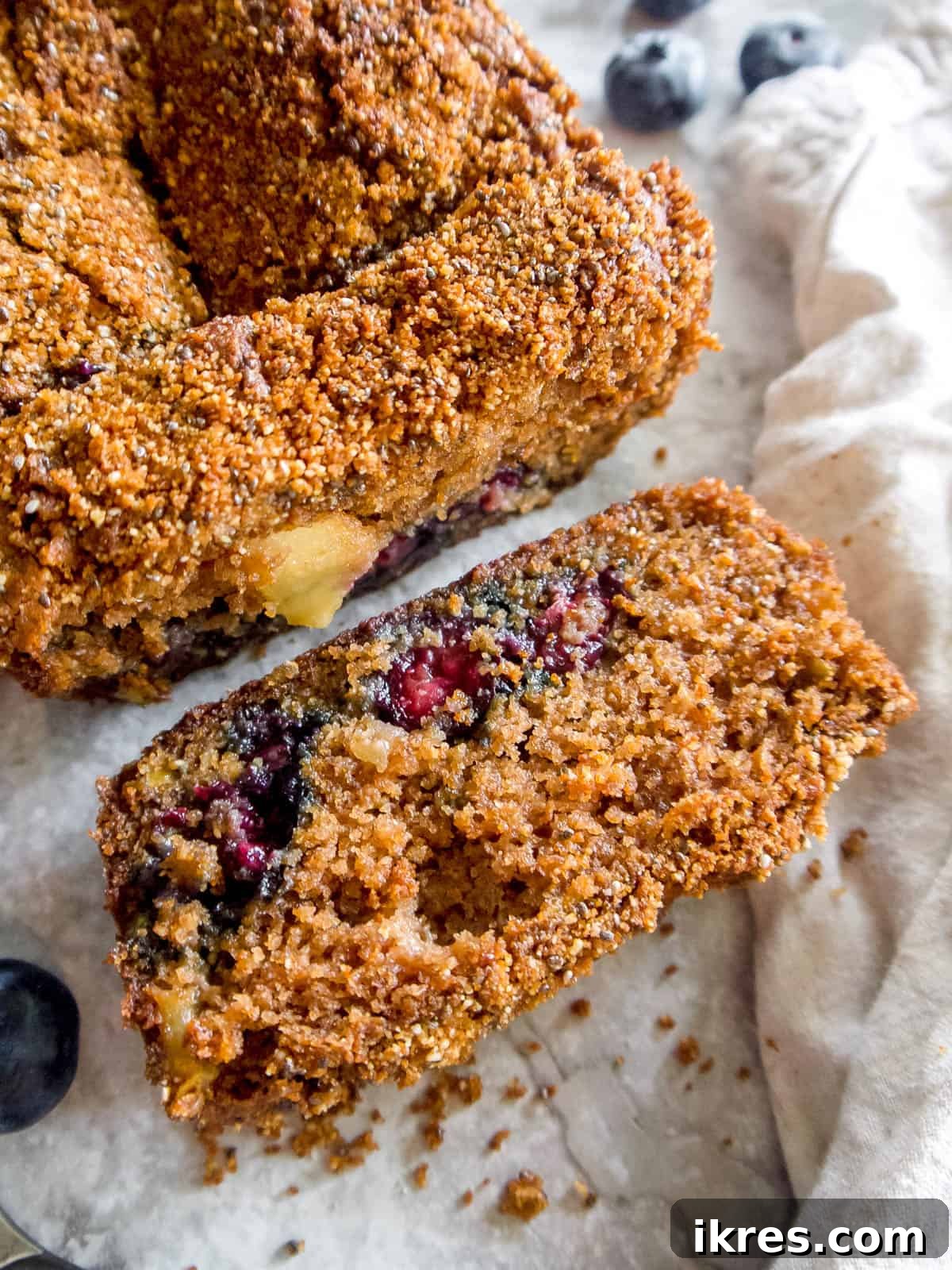 A beautifully baked slice of almond flour apple bread on a rustic wooden table.