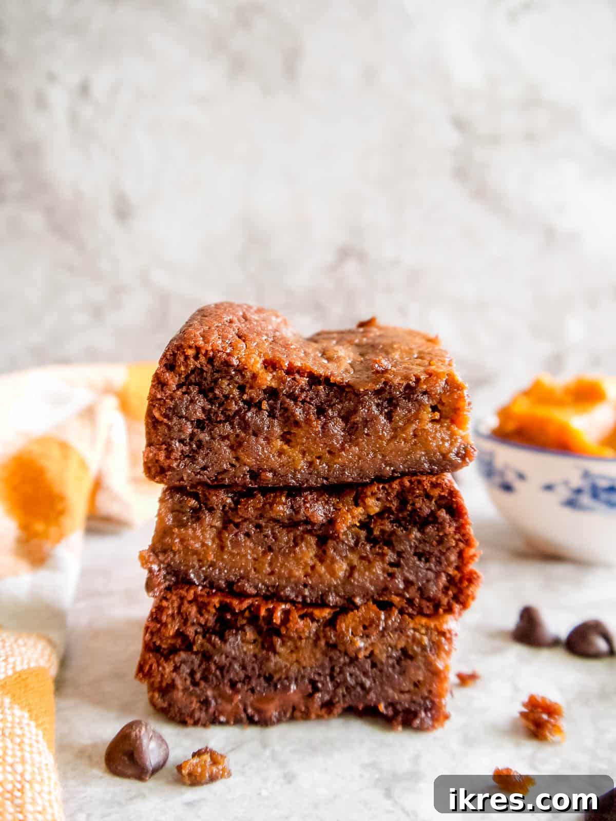 Stacks of Paleo pumpkin brownies, highlighting their thick, fudgy consistency.