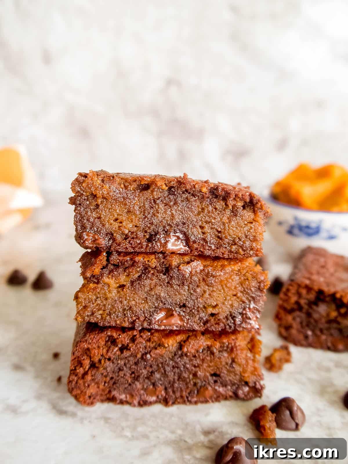 Paleo and gluten-free pumpkin swirl brownies artfully stacked.