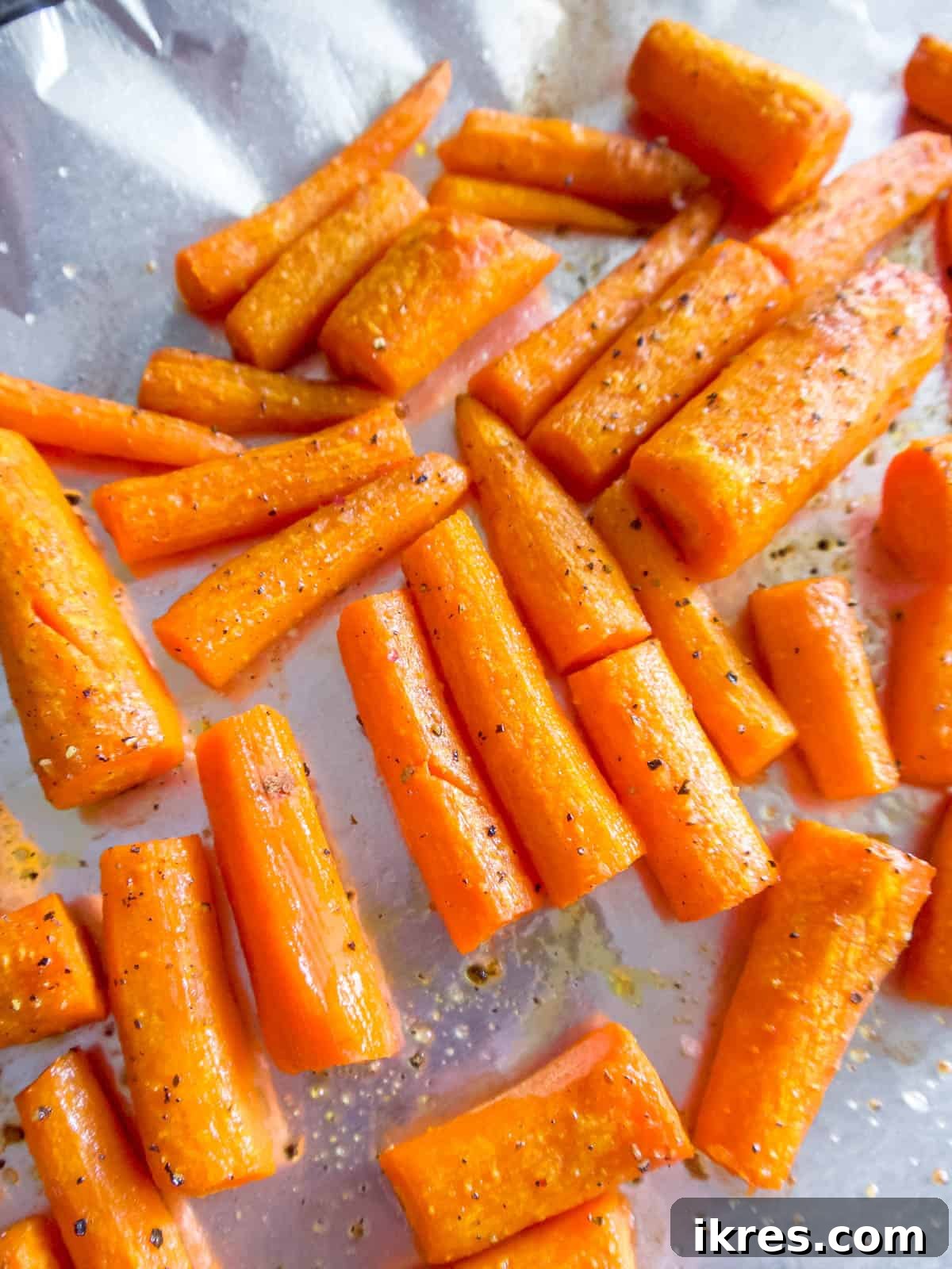 Peeled carrots cut into 2 inch pieces to be roasted.