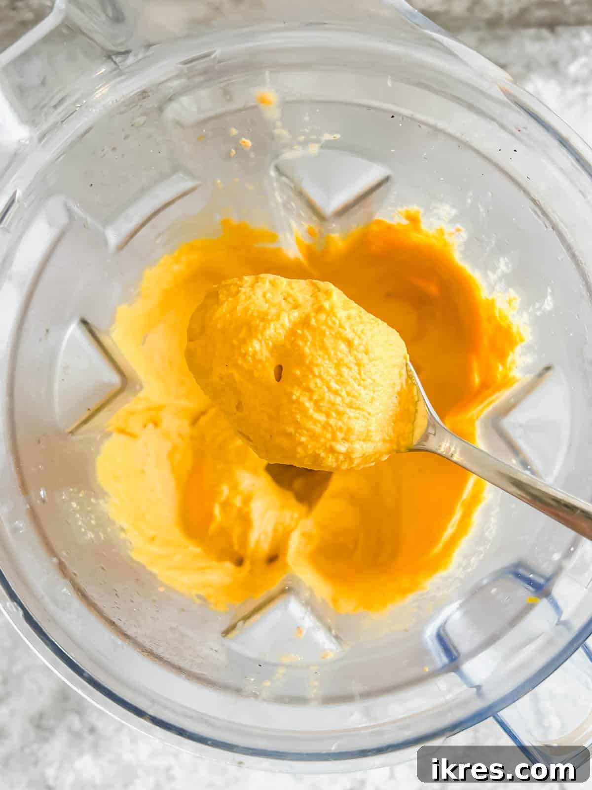 Spoonful of carrot hummus straight out of the blender.