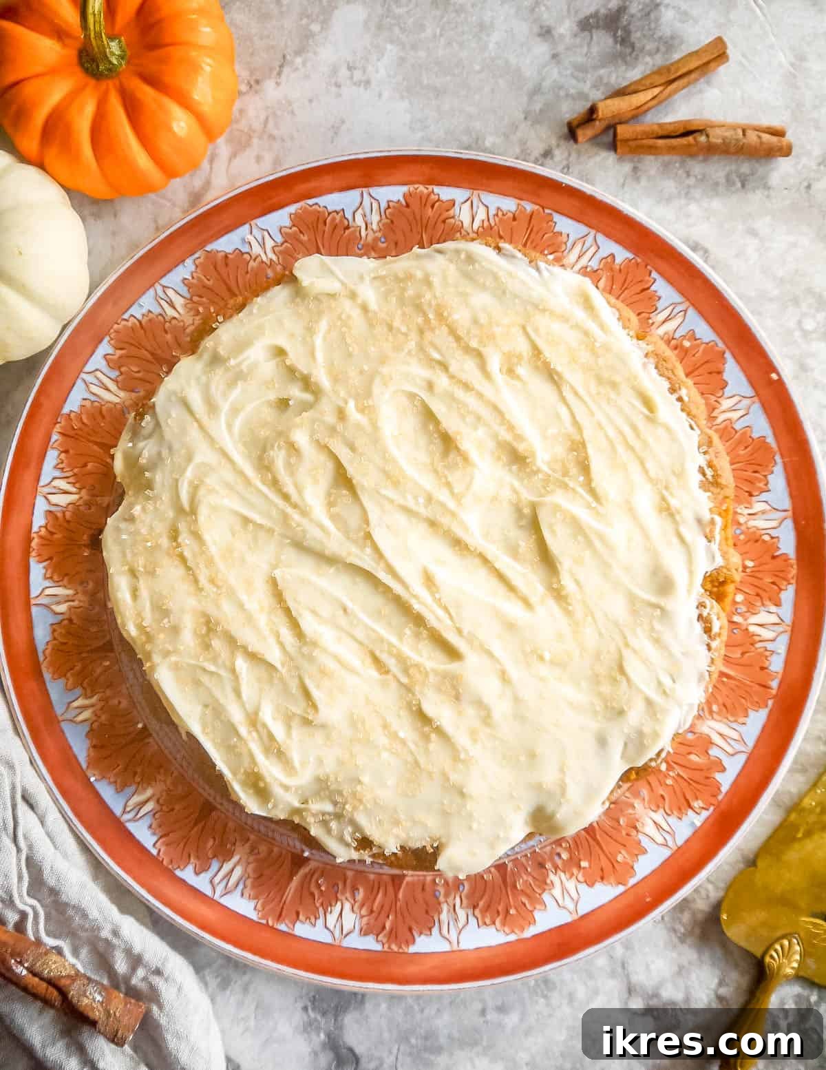 Artisanal Pumpkin Olive Oil Cake 12 The almond flour pumpkin cake is beautifully frosted with a generous layer of cream cheese frosting, making it an inviting dessert.
