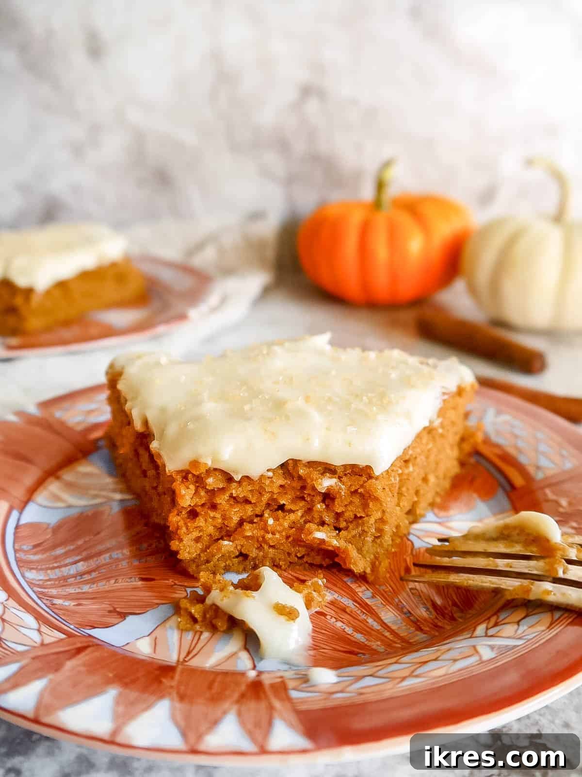 Artisanal Pumpkin Olive Oil Cake 14 A slice of healthy pumpkin cake on a plate, with a bite taken out, showcasing its inviting texture and deliciousness.