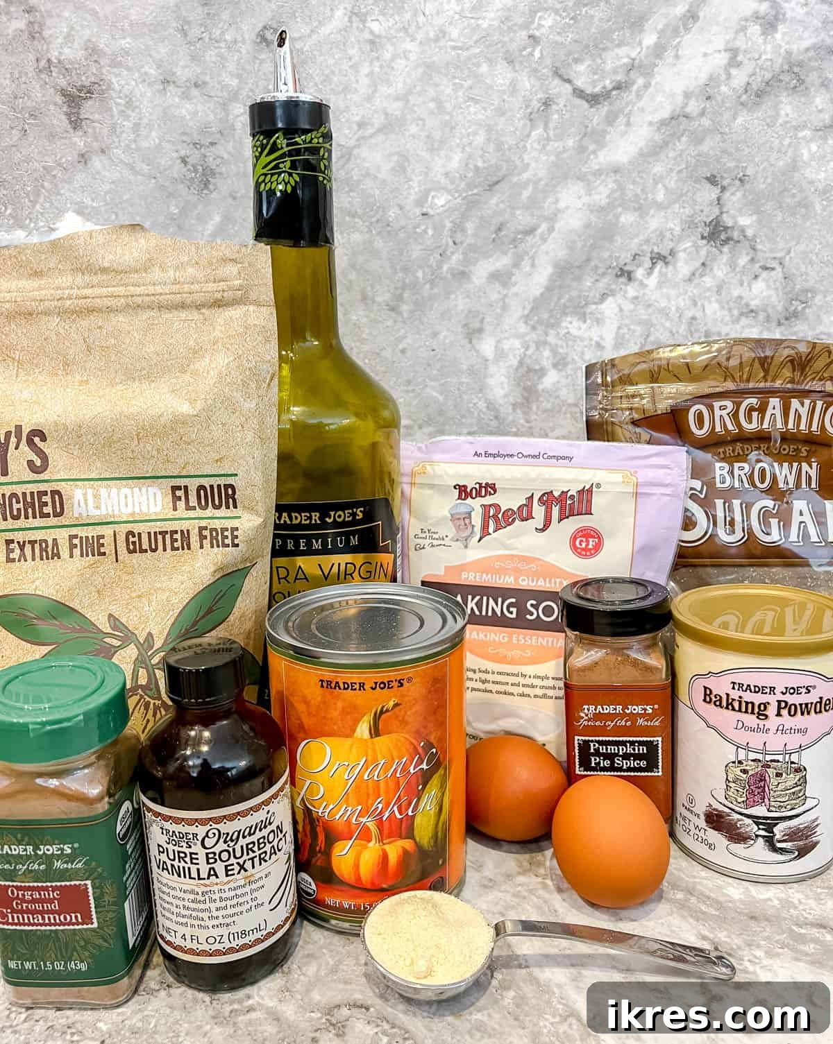 Artisanal Pumpkin Olive Oil Cake 4 A collection of dry ingredients laid out, featuring almond flour, coconut flour, baking powder, baking soda, salt, cinnamon, and pumpkin pie spice, ready for mixing to create the almond flour pumpkin cake with olive oil.