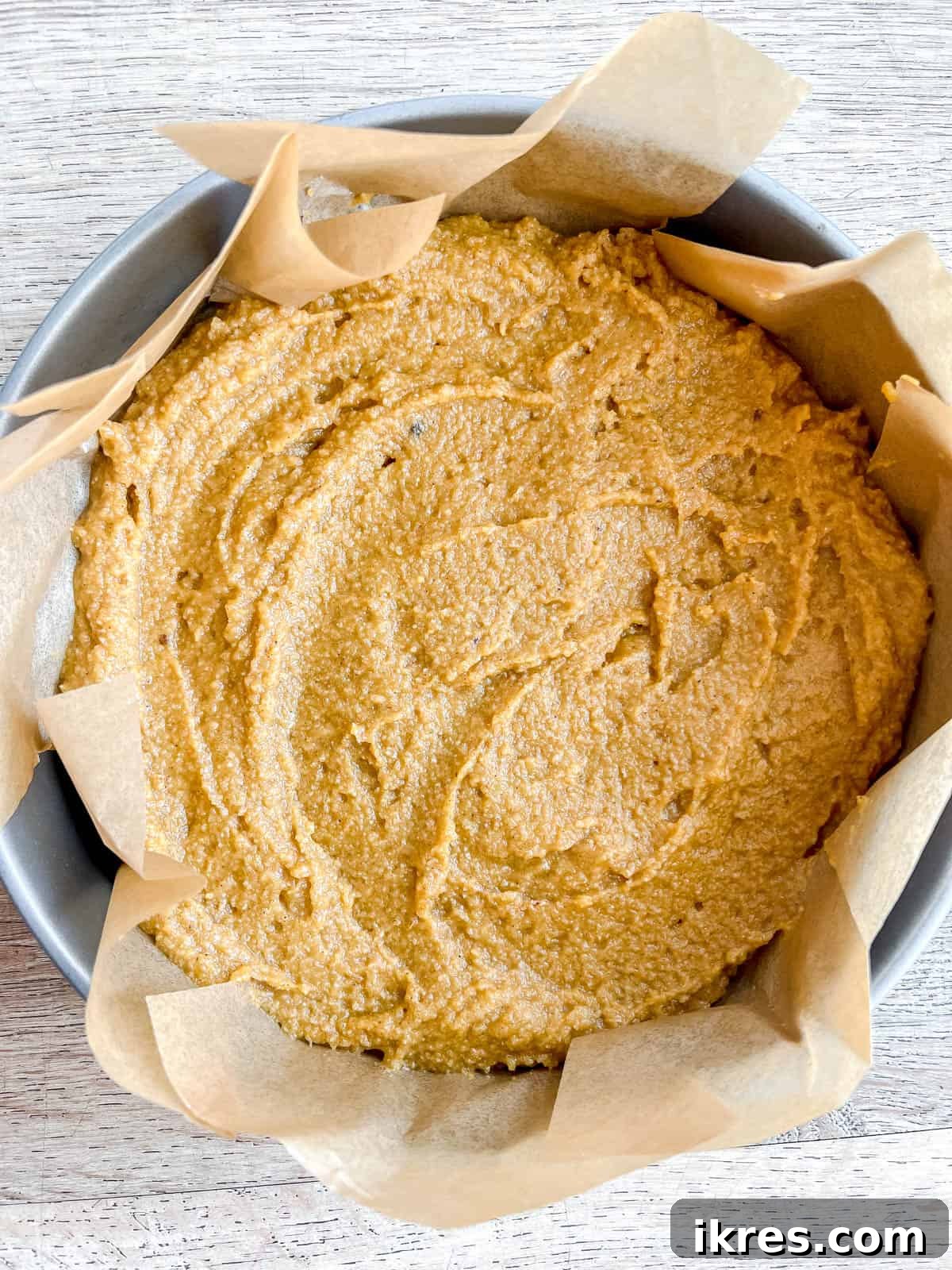 Artisanal Pumpkin Olive Oil Cake 9 The unbaked pumpkin olive oil cake batter is poured into a lined cake tin, ready for the oven.