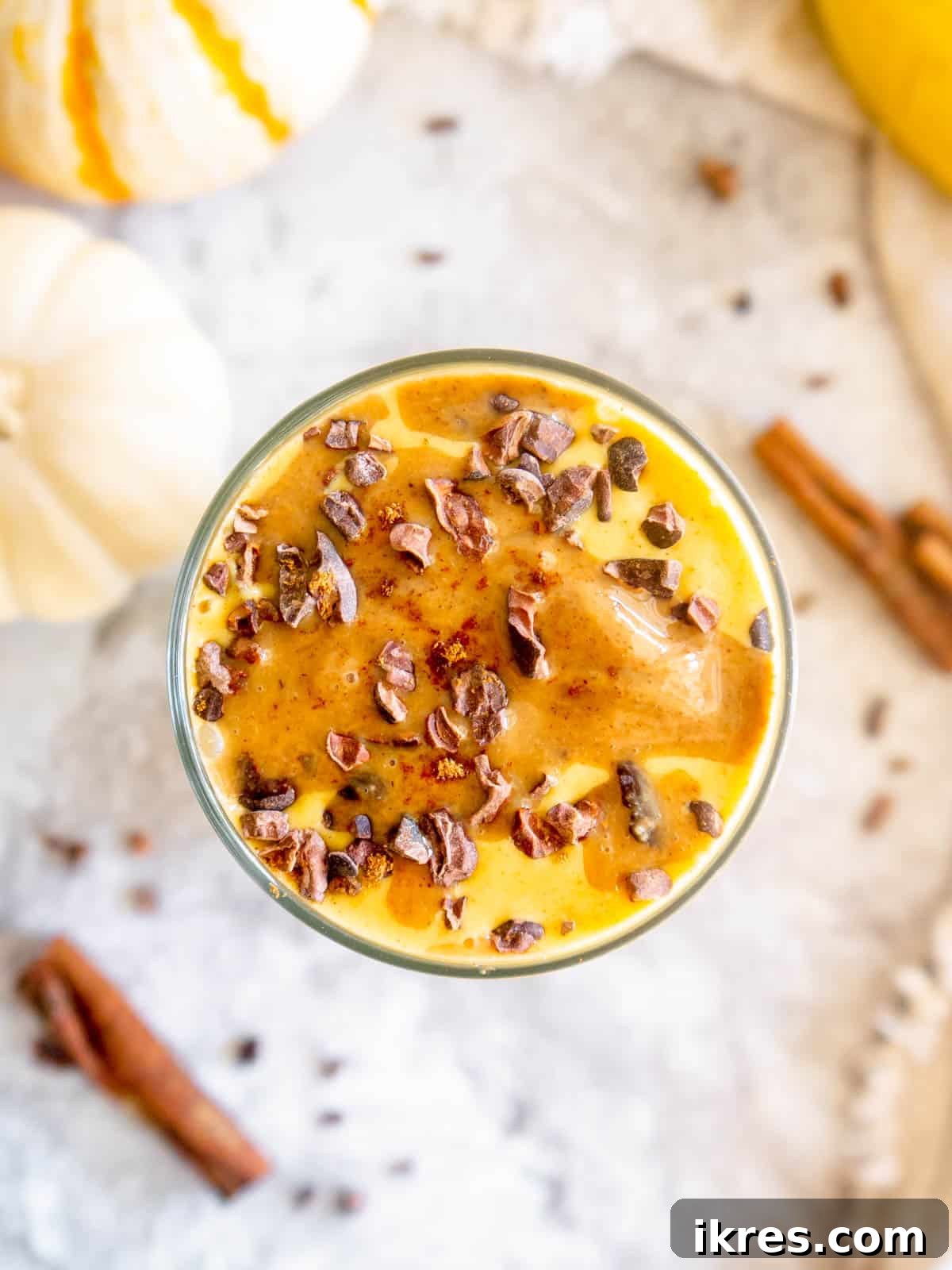 Autumn Spiced Pumpkin Banana Delight 5 An aerial view of a delightful Pumpkin Banana Smoothie garnished with fresh banana slices.